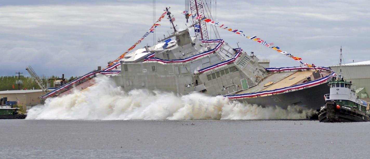 The USS Minneapolis-Saint Paul is launched into the Menominee River from Fincanteiri Marinette Marine in Marinette Wis., on Saturday, June 15, 2019. (Rick Gebhard/The Eagle Herald via AP)