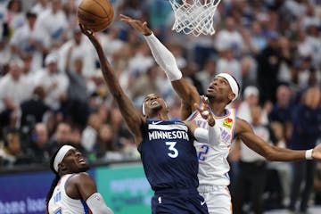 Timberwolves forward Jaden McDaniels (3) goes up for a shot as Thunder guard Shai Gilgeous-Alexander (2) defends in the first quarter at Target Center