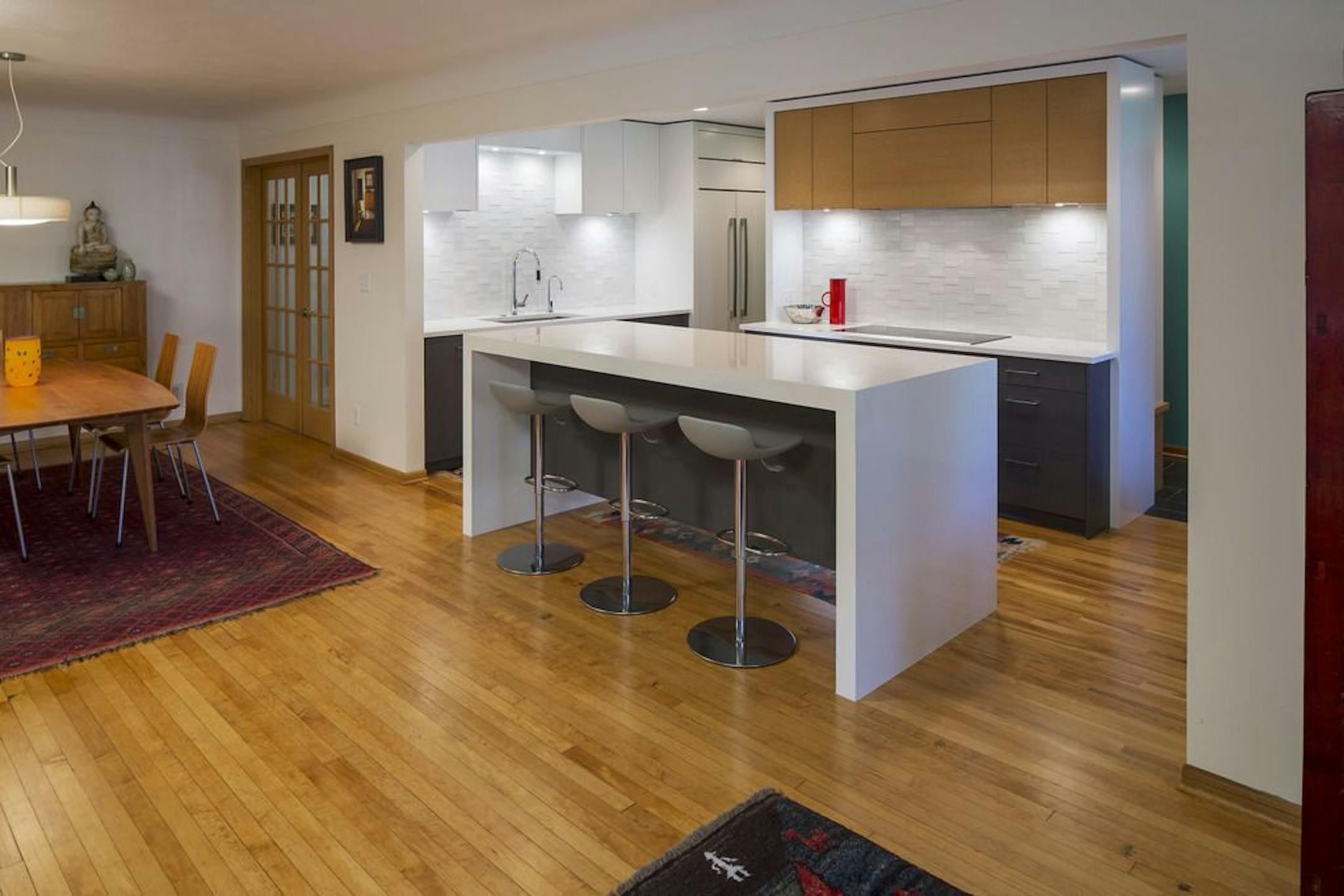 AFTER Kell Architects new floor plan for the 1950s St. Paul rambler removed the wall between the dining/living areas and kitchen to create an open great room anchored by the remodeled kitchen.