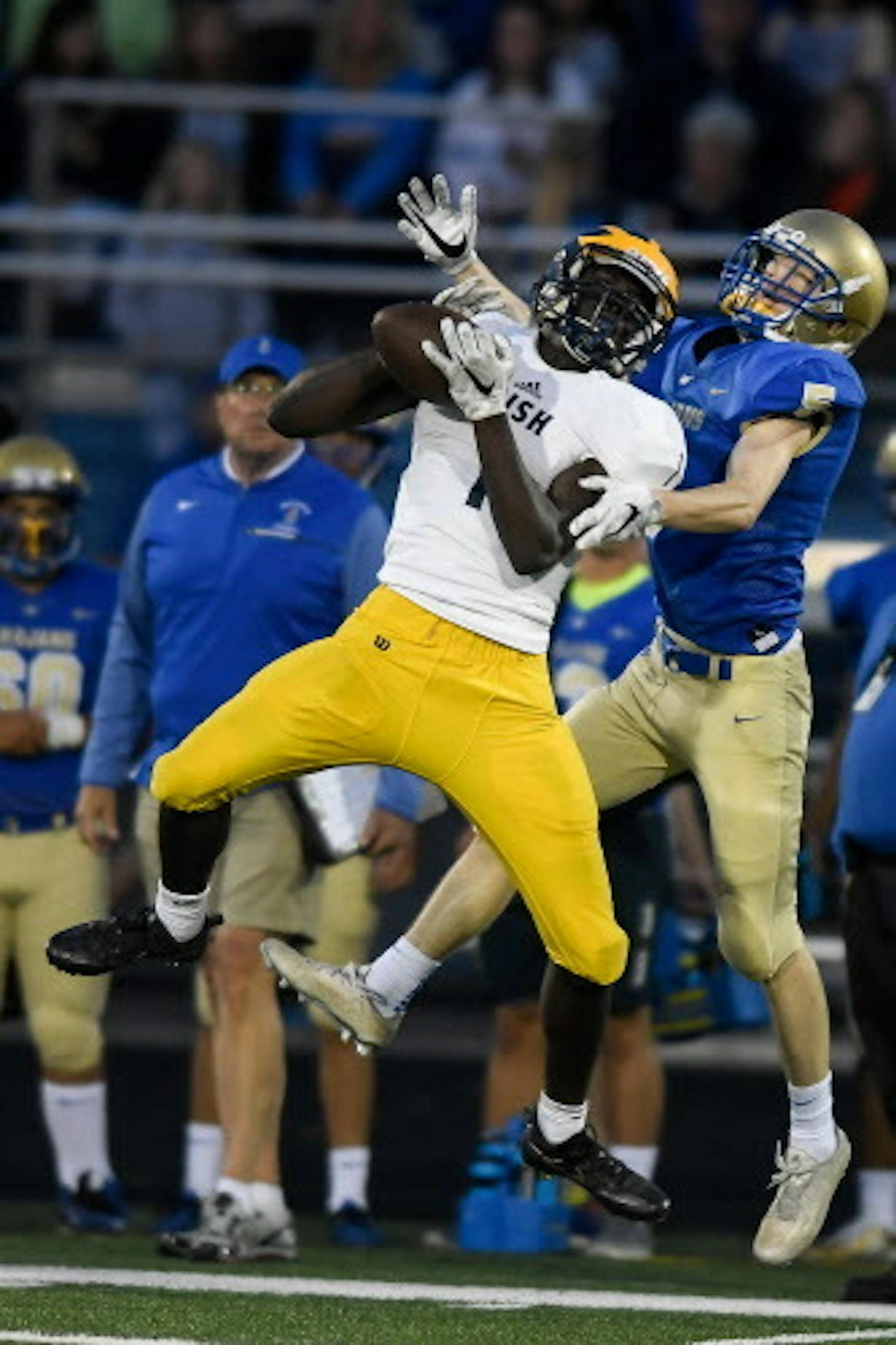 Rosemount running back Jonathan Mann (1) pulled down a pass for a touchdown in the second quarter despite the defensive efforts of Wayzata defensive back Jacob Beeninga (5). ] AARON LAVINSKY ' aaron.lavinsky@startribune.com