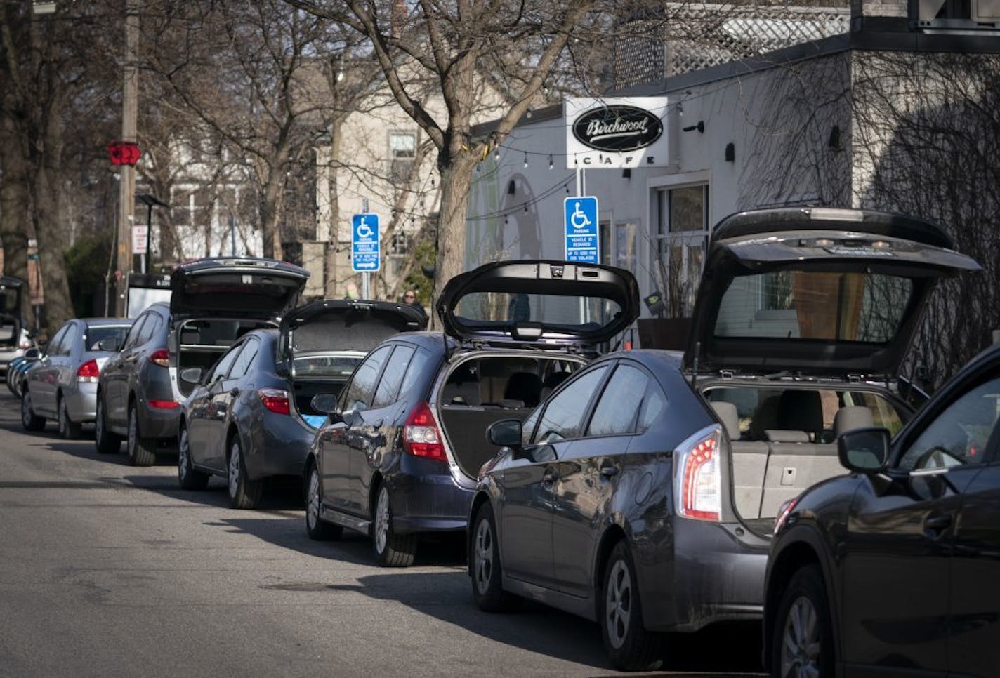 Cars lined the street in front of the Birchwood Cafe for take out orders as the restaurant sold out of it's Friday fish fry in Minneapolis, Minn., on Friday, April 10, 2020.