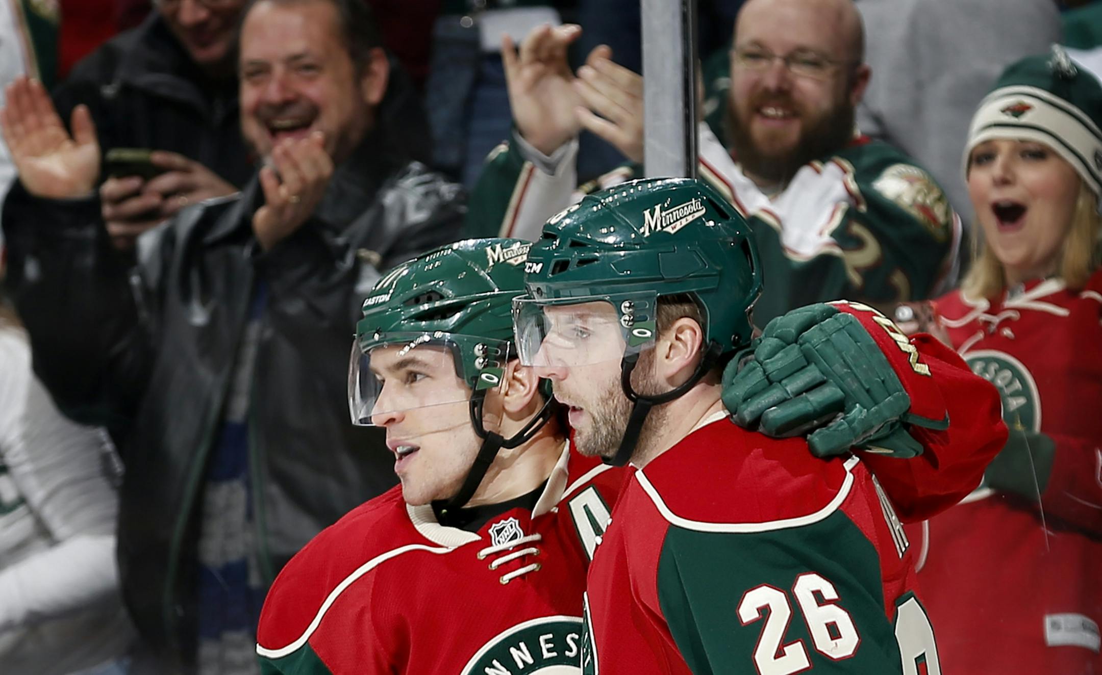 Zach Parise (11) celebrated with Thomas Vanek (26) after Parise scored a goal in the first period.