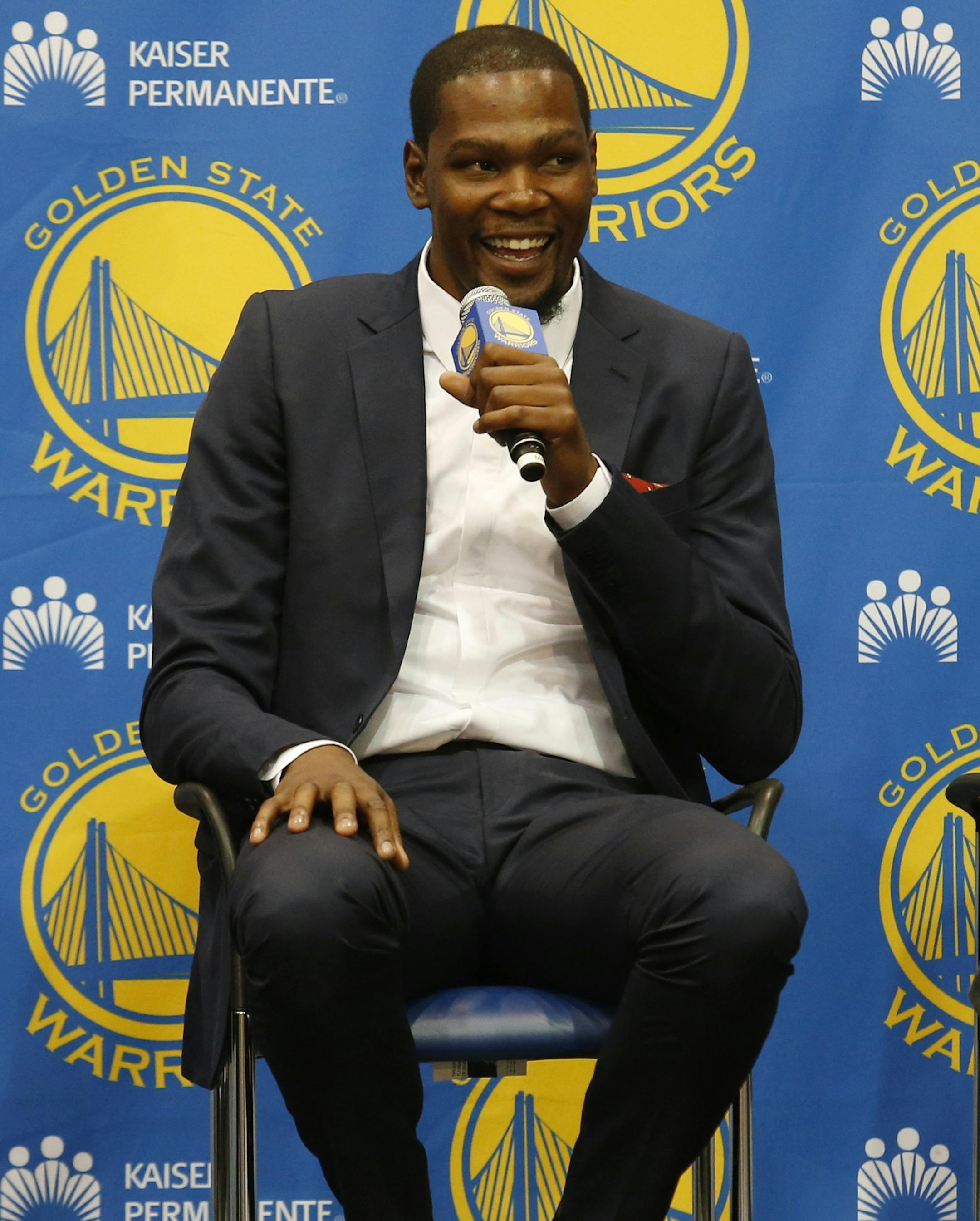 Golden State Warriors' Kevin Durant, center, speaks as coach Steve Kerr, left and general manager Bob Myers listen during a news conference at the NBA basketball team's practice facility, Thursday, July 7, 2016, in Oakland, Calif. (AP Photo/Beck Diefenbach)