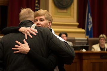 Minneapolis Park Board Commissioner Jon Olson hugged superintendent Jayne Miller before the start of Wednesday night's city council meeting in which M