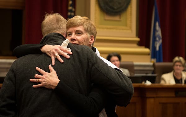 Minneapolis Park Board Commissioner Jon Olson hugged superintendent Jayne Miller before the start of Wednesday night's city council meeting in which M