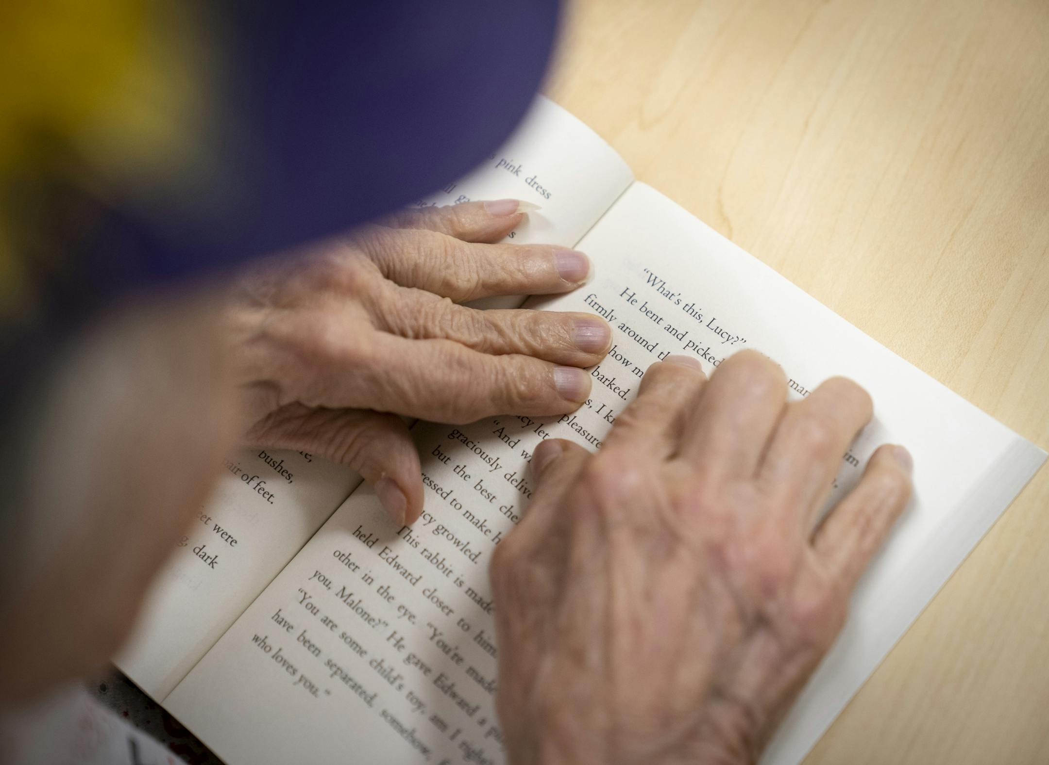 Sandra Lindell used her hands to guide her as she read The Miraculous Journey of Edward Tulane by Kate DiCamillo during the Rock Star Book Club at Fraser in Apple Valley, Minn., on Tuesday, December 3, 2019. ] RENEE JONES SCHNEIDER &#xa5; renee.jones@startribune.com