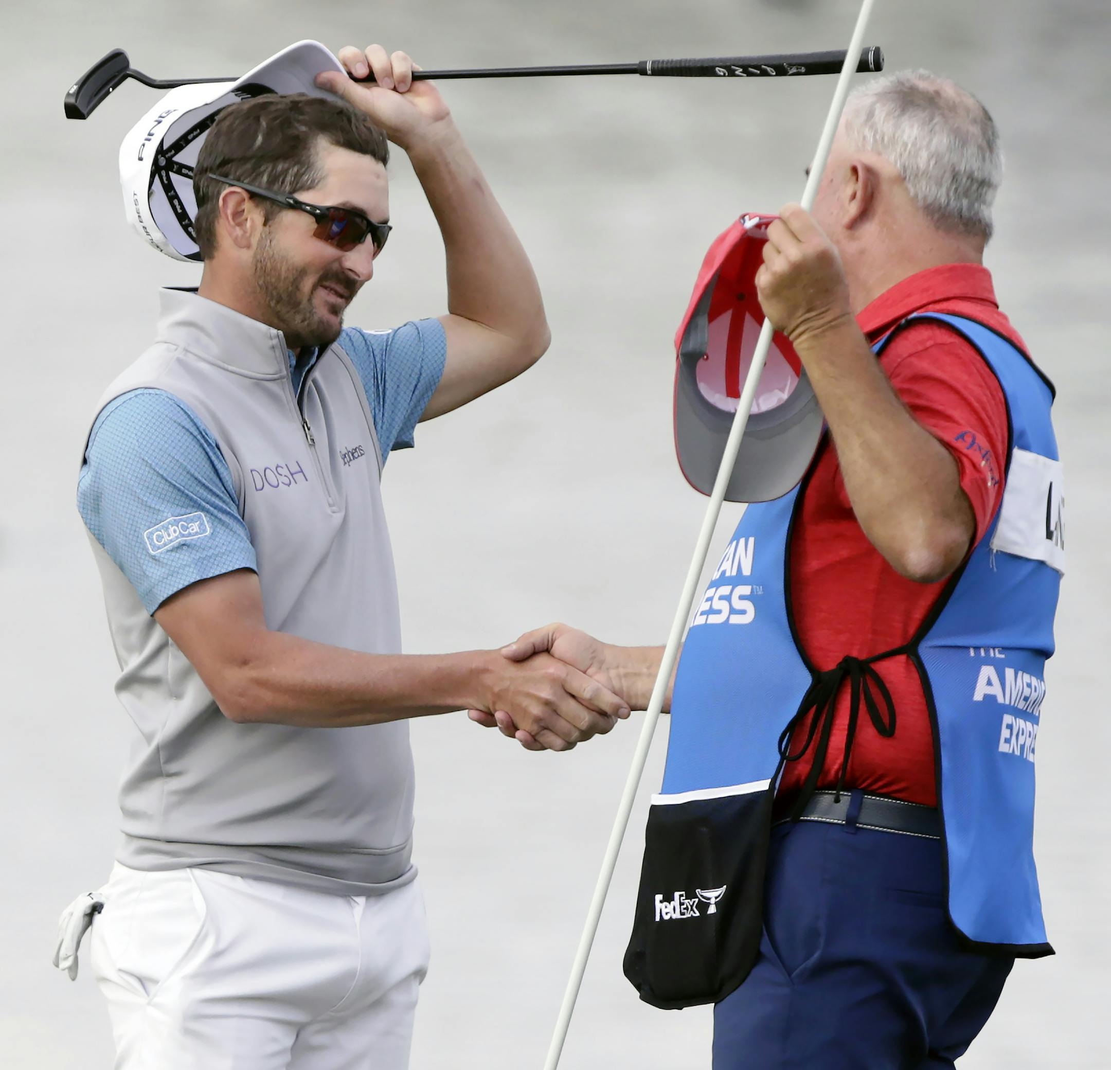 Andrew Landry, left, celebrates with his caddie Terry Walker after winning The American Express golf tournament on the Stadium Course at PGA West in La Quinta, Calif., Sunday, Jan. 19, 2020. (AP Photo/Alex Gallardo)