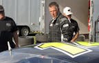 In this July 6, 2017 photo, Vermont Gov. Phil Scott walks beside his stock car at the Thunder Road race track in Barre, Vt., where he won the evening'