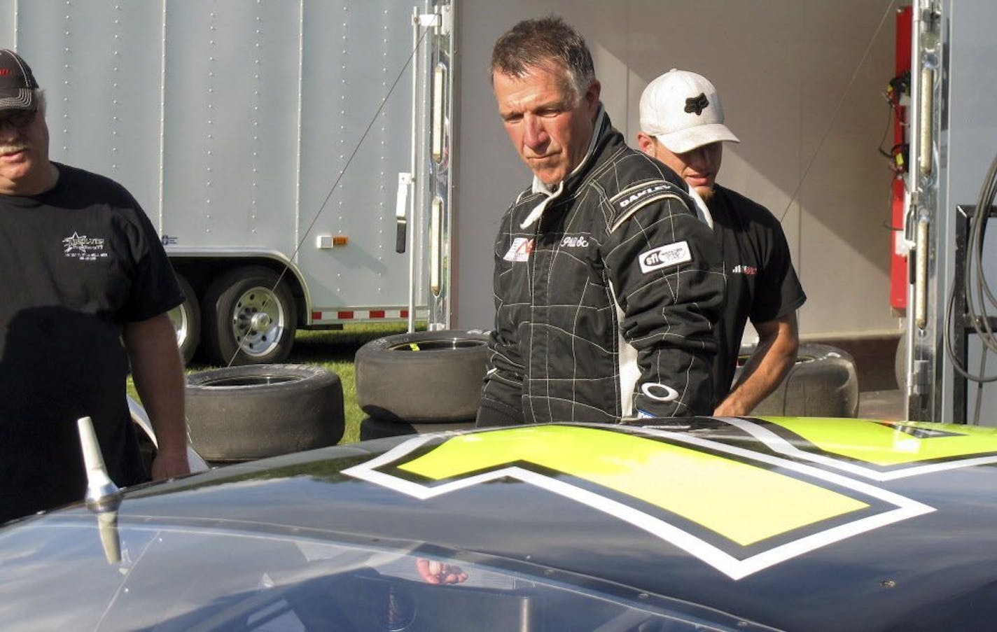 In this July 6, 2017 photo, Vermont Gov. Phil Scott walks beside his stock car at the Thunder Road race track in Barre, Vt., where he won the evening's 50-lap feature race, his 30th lifetime win. Scott spends most of his time working as governor, but he still tries to race whenever he can.