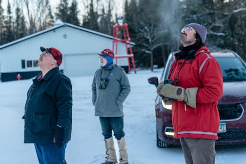 Aaron Brown, John Latimer and Malachy Koons look for birds on Dec. 14, 2025 during a stop on the annual Christmas Bird Count in Itasca County.