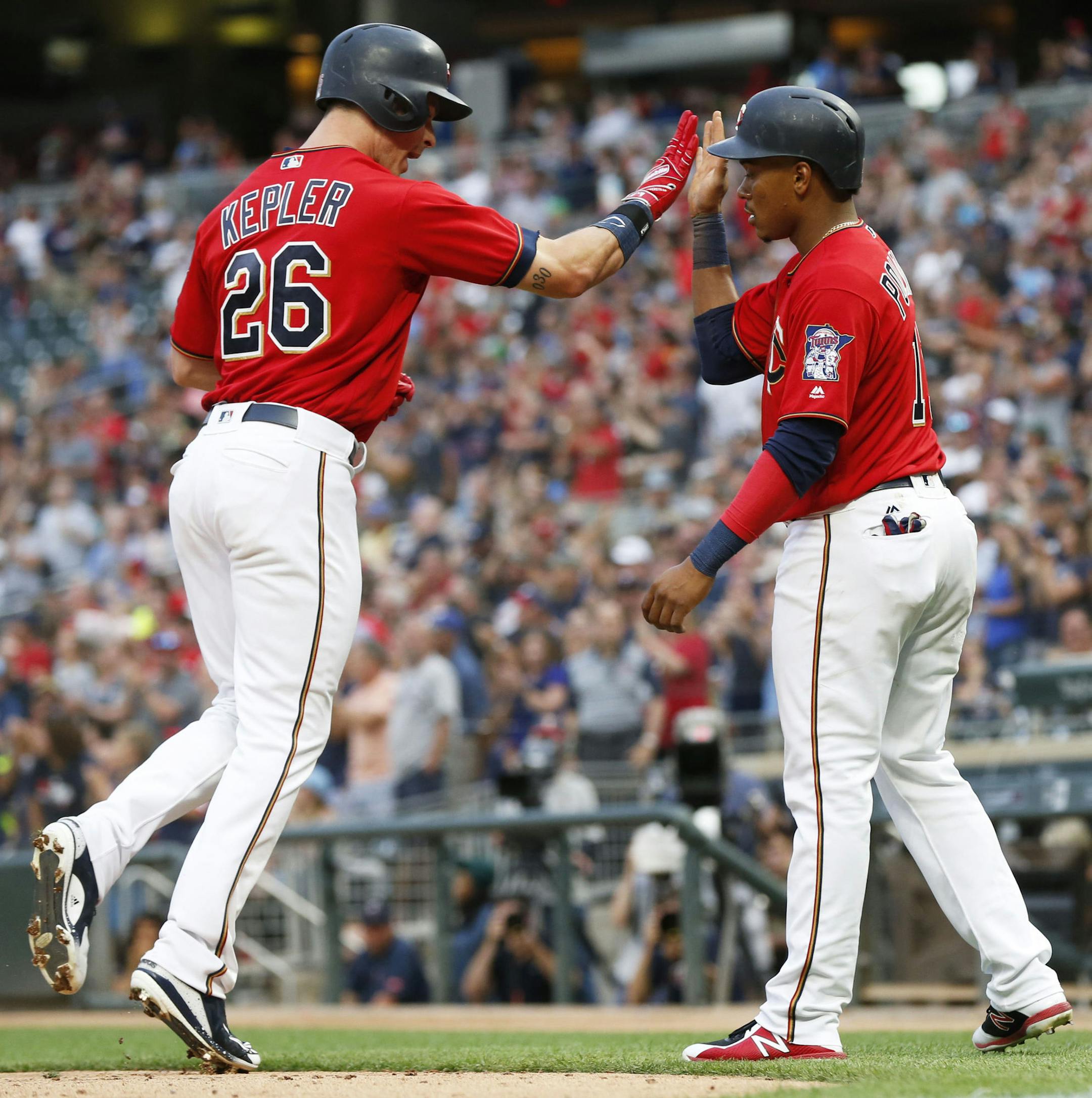 Minnesota Twins' Max Kepler, left, and Jorge Polanco celebrate Kepler's two-run home run off Baltimore Orioles pitcher Dylan Bundy in the fourth inning of a baseball game Friday, July 6, 2018, in Minneapolis. (AP Photo/Jim Mone)
