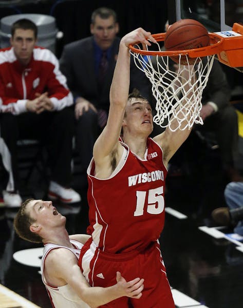 Wisconsin's Sam Dekker (15) dunks over Indiana's Cody Zeller during the second half of an NCAA college basketball game at the Big Ten tournament Satur