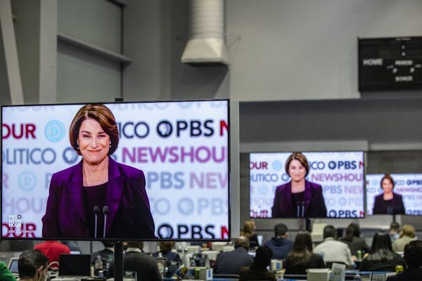Screens show Sen. Amy Klobuchar (D-Minn.) during the Democratic presidential debate co-hosted by PBS and Politico at Loyola Marymount University in Lo