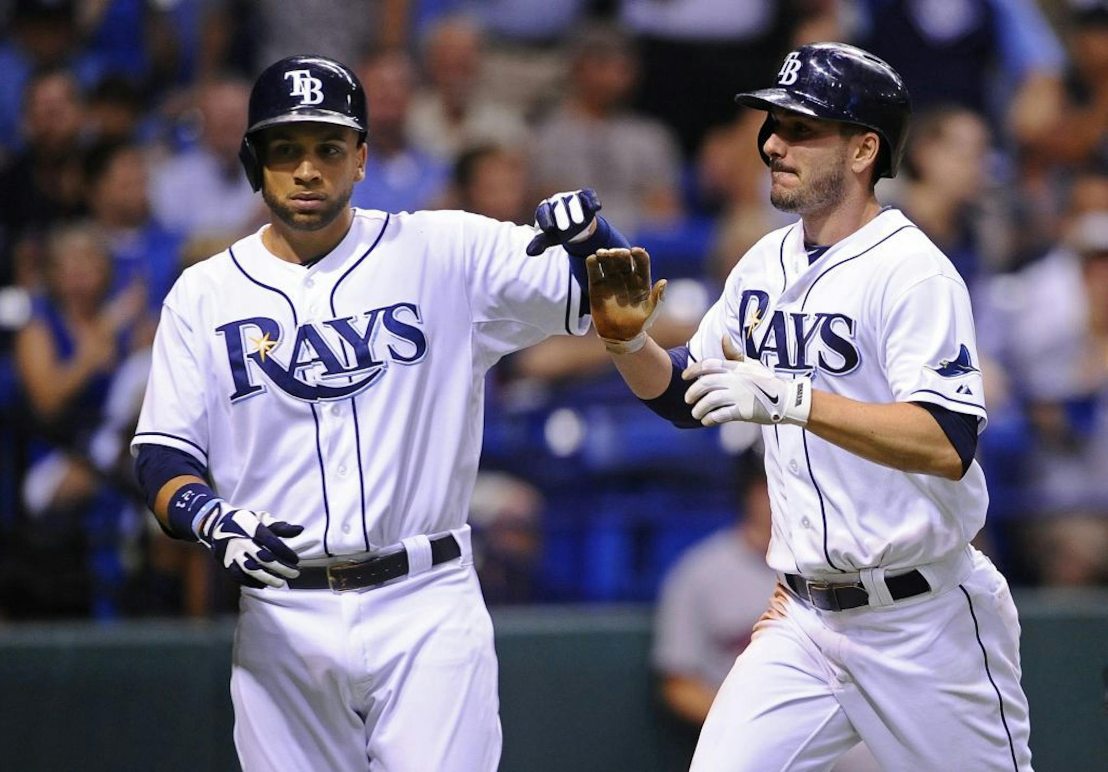 Tampa Bay Rays' James Loney, left, and Matt Joyce celebrate at the plate after both scoring off of Kelly Johnson's two-run double off of Minnesota Twins starting pitcher Kyle Gibson during the fourth inning of a baseball game Tuesday, July 9, 2013, in St. Petersburg, Fla.