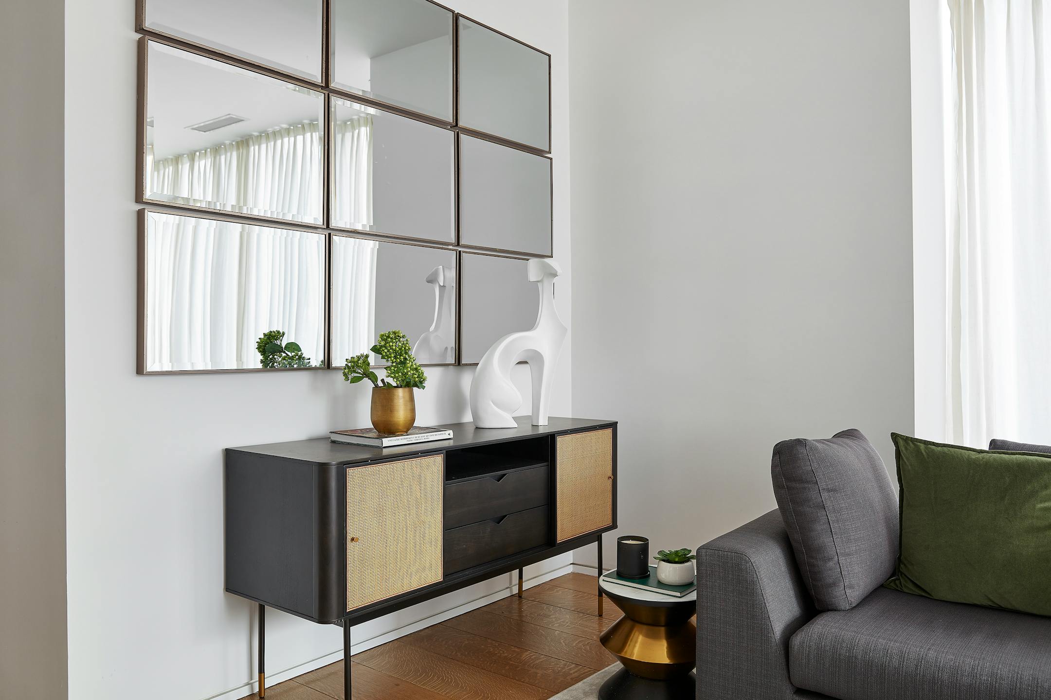 Mirrors hung in series of threes help reflect light in this home/work environment. (Scott Gabriel Morris/TNS)