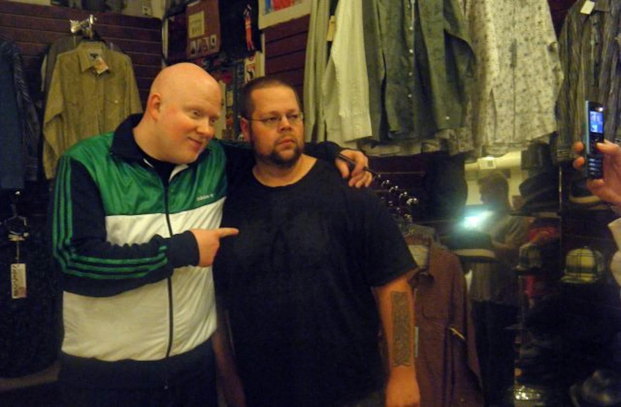 Brother Ali - left, poses with fans at a autograph session at the electric fetus record store in Duluth before performing across the street at Pizza Luce