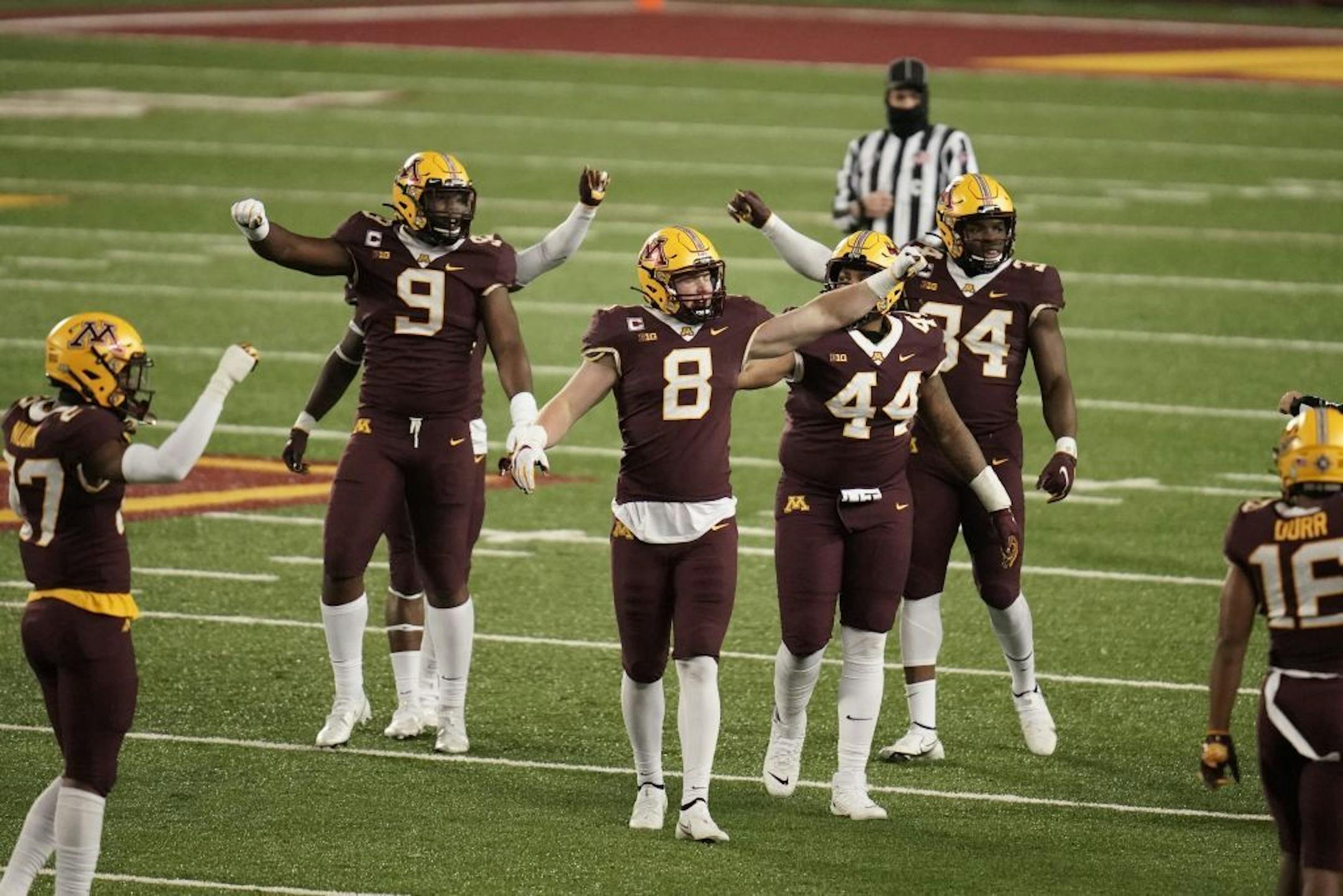 Minnesota Gophers linebacker Thomas Rush (8) and teammates celebrated ending an Iowa Hawkeyes second quarter drive.