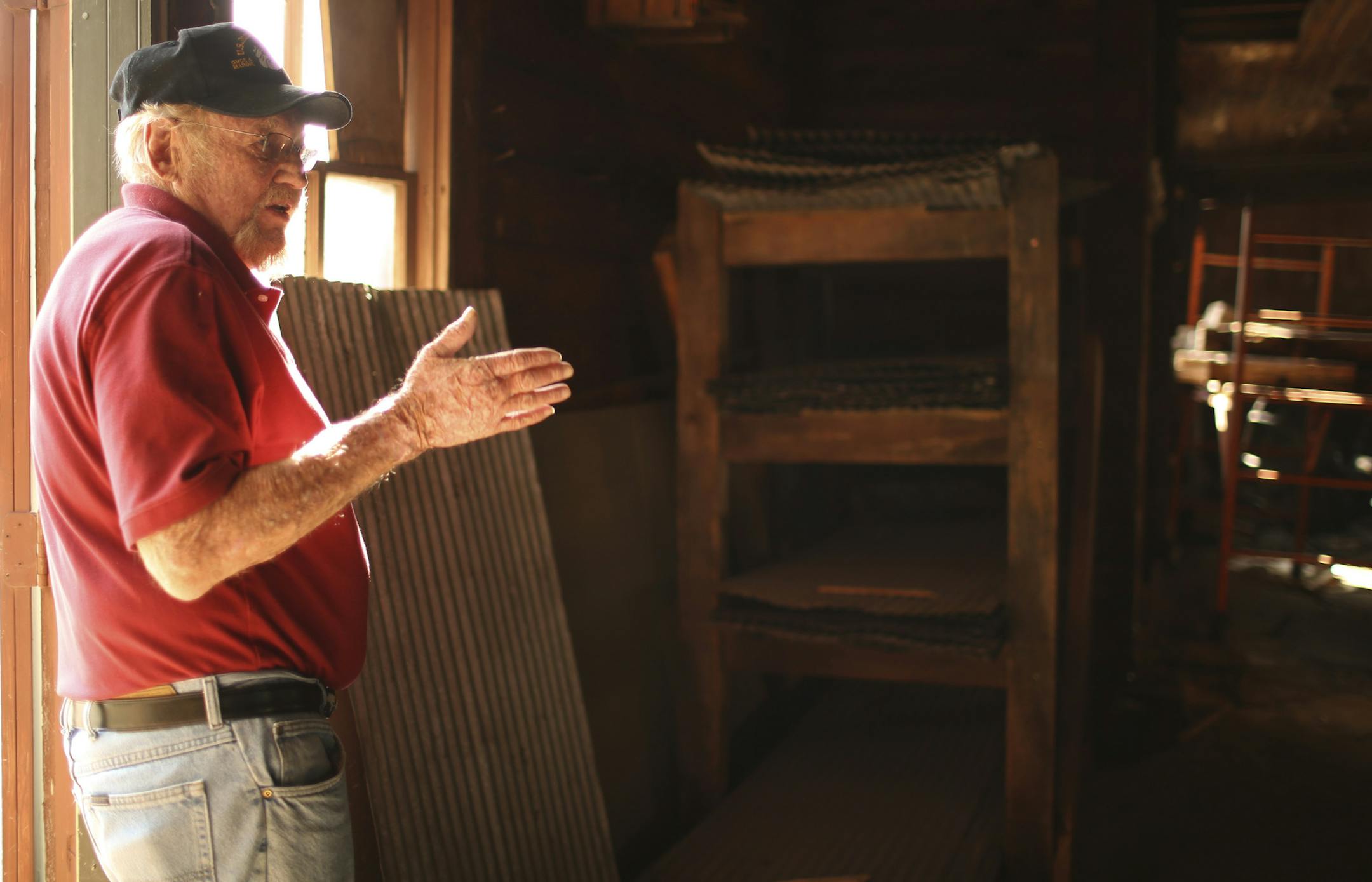 An old barn in "downtown" Scandia is slated for demolition, but some people are trying to save it as a historic centerpiece to this early Swedish community. The city says it's a fire hazard. The barn sits over the well of a water company and evidently once was used to support a water tower. Wayne Schmitt inside the historic structure in downtown Scandia, Minn. that might be demolished to expand a parking lot. He owns a share of the building and would like to see it preserved. This photograph was