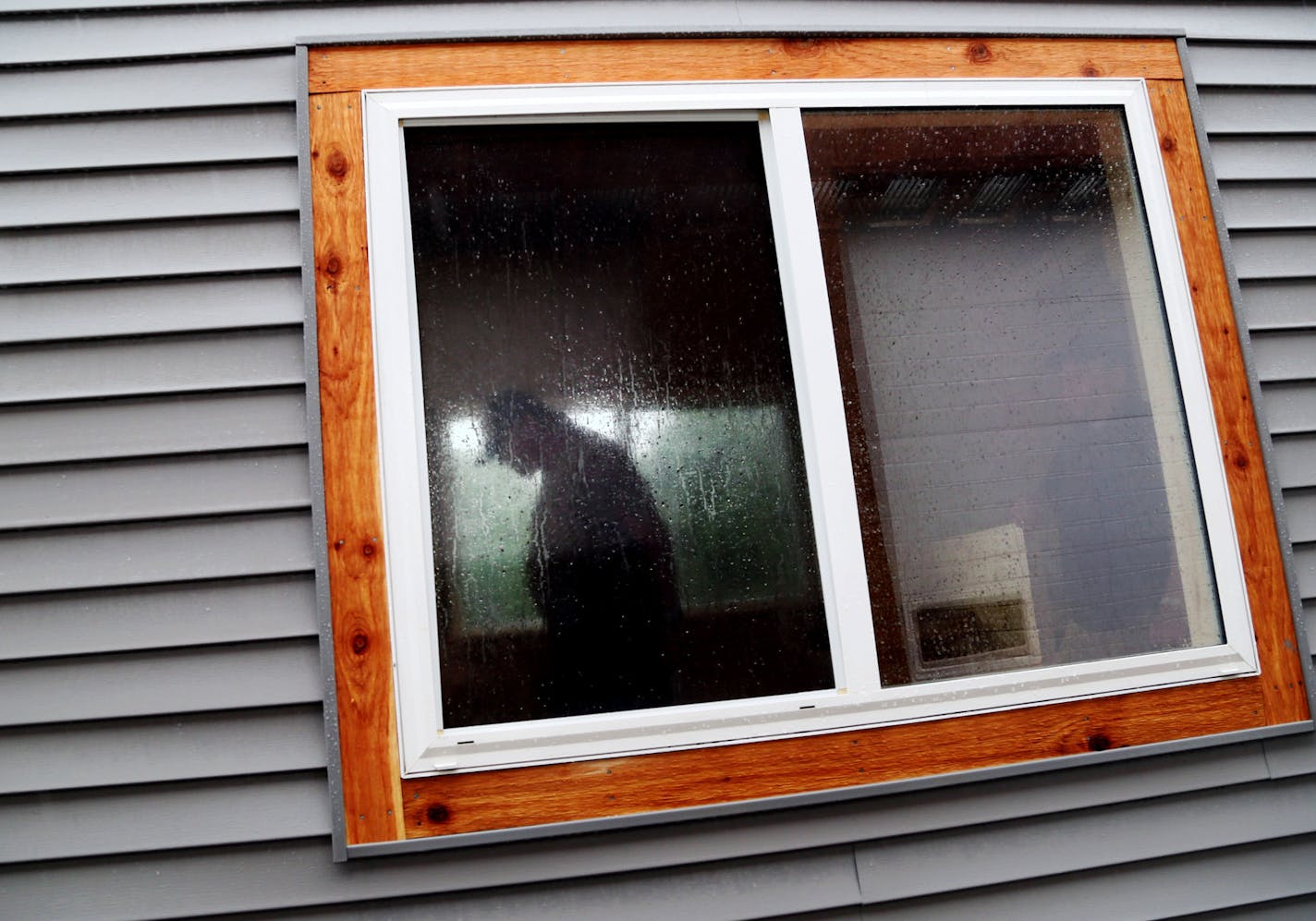 The rain-shrouded sihloutee of Dave, who will be living in this tiny house being built by students at the Willmar Alternative Learning Center at the Kandiyohi County public works building and was seen Wednesday, June 3, 2015, in Willmar, MN. ](DAVID JOLES/STARTRIBUNE)djoles@startribune.com St. Cloud will soon get its first tiny house, parked on a church lot. The 128 foot tiny house, spearheaded by the St. Cloud Coalition for Homeless Men, is being built by high school students from the Willmar A