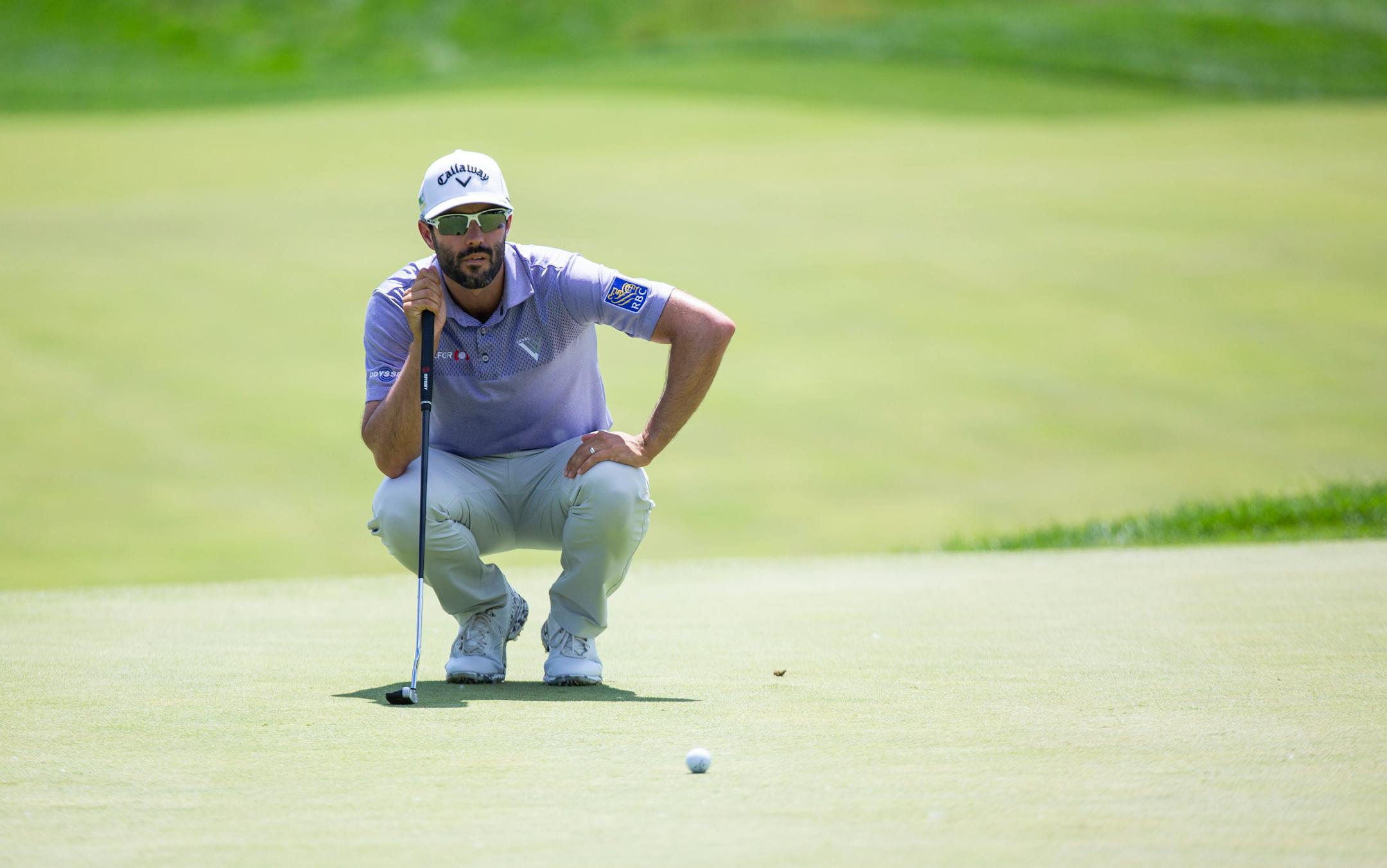 Adam Hadwin kneels down to line up his putt on the first hole. ALEX KORMANN ¥ alex.kormann@startribune.com Competitors for the 3M Open took to the course on Saturday.