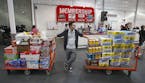 David Lee holds on to his carts while shopping at a Costco Wholesale in Portland, Ore.