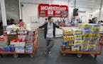 David Lee holds on to his carts while shopping at a Costco Wholesale in Portland, Ore.
