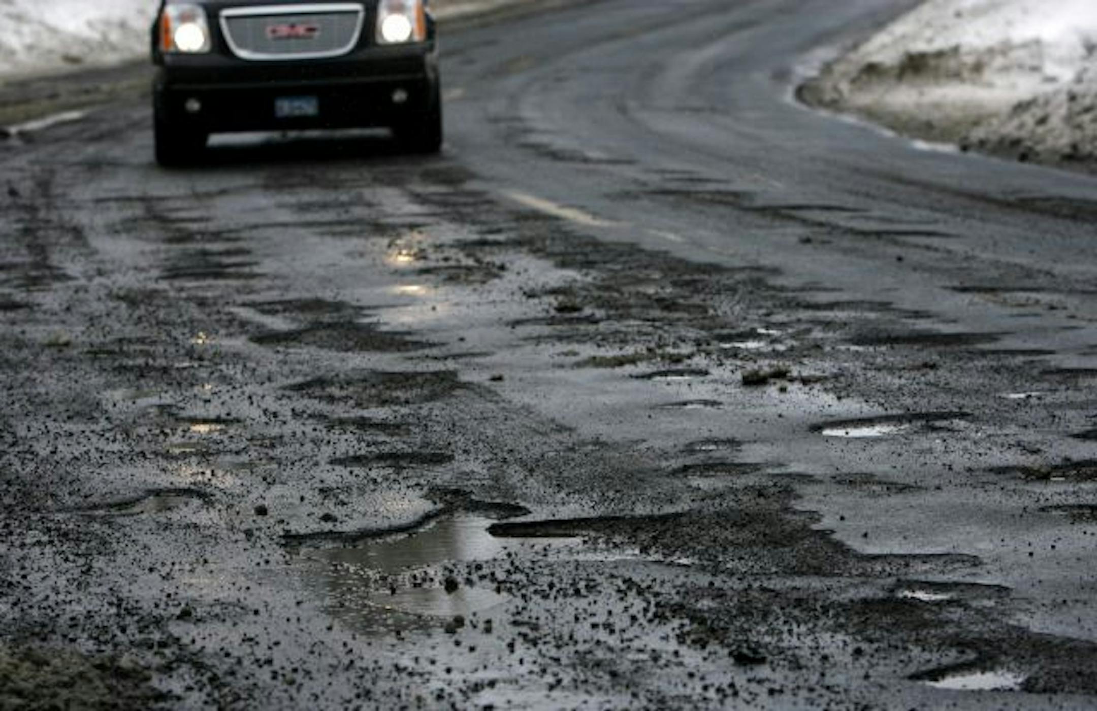Parts of Modern Road in Brooklyn Park are pitted with potholes.