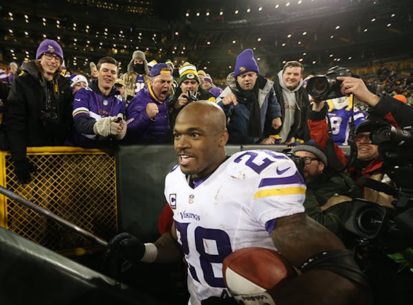 Minnesota Vikings running back Adrian Peterson (28) celebrated with fans after the win Sunday January 3, 2016 in Green Bay, Wisconsin.