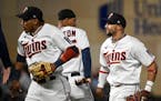From left, Minnesota Twins second baseman Jorge Polanco (11), designated hitter Byron Buxton (25) and shortstop Royce Lewis (23) celebrate their team'