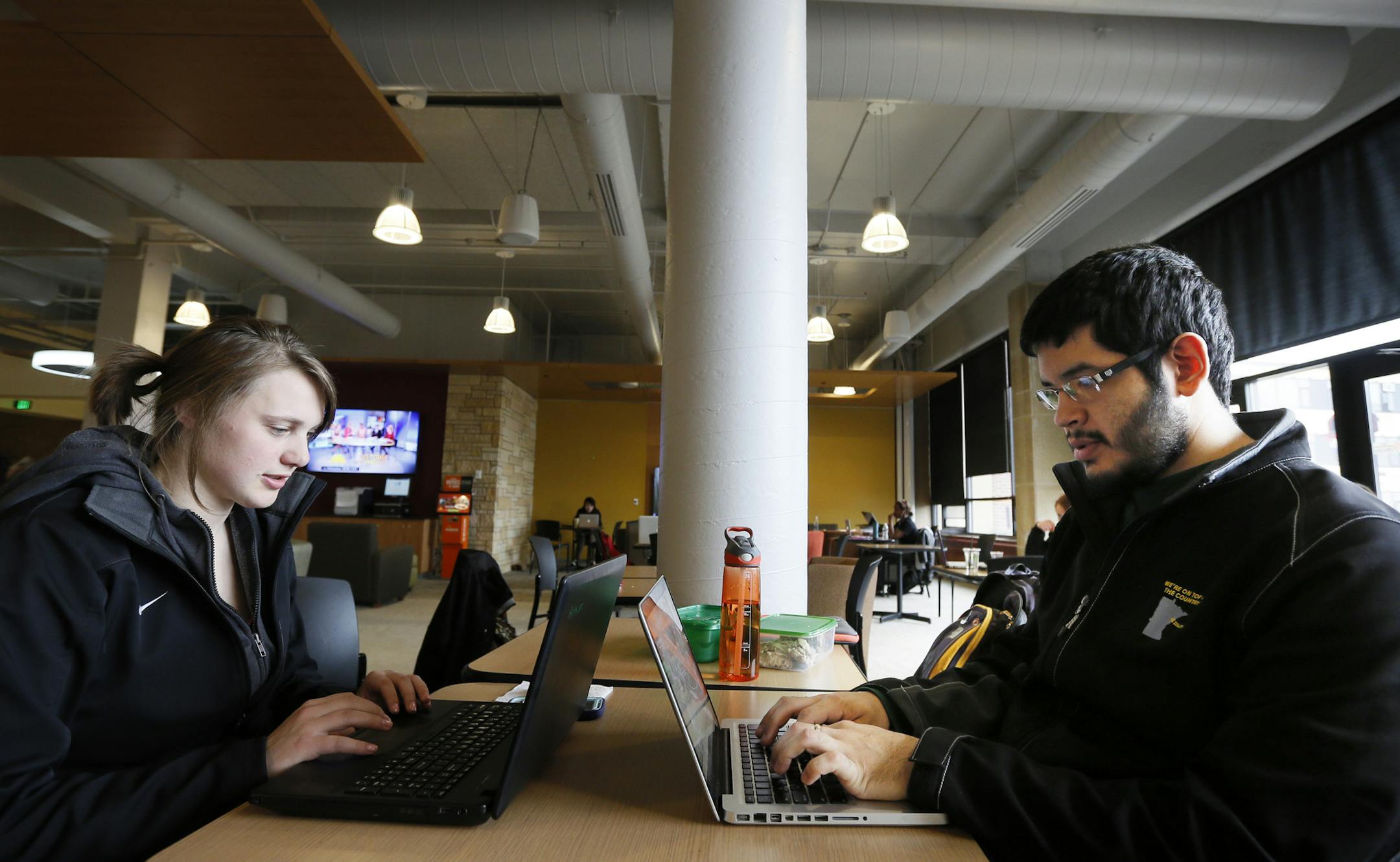 UMD students Jessica Newman, 21, left, and Andrew Fuerte, 22, worked on their laptops in the student center, preparing for final exams. Says Jessica,"There's been a lot of talk of budget cuts" among faculty and staff. "I guess the only thing I care about is my tuition going up or down." University of Minnesota Duluth chancellor, Lendley Black hosted a "Town Hall" meeting for faculty, staff and students to give and update on the progress toward digging the Duluth campus out of of a multi-million