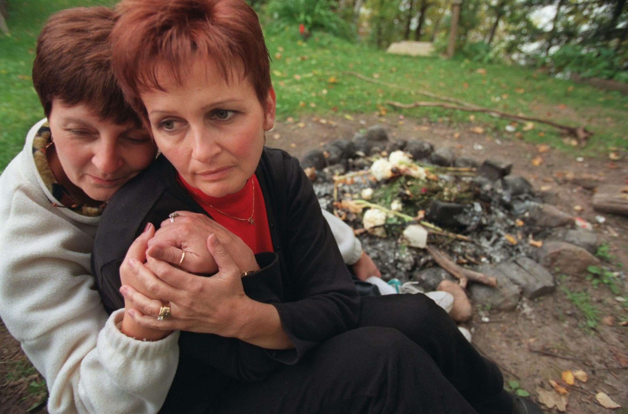 Pam Poirier, mother of Katie Poirier, and Pam's sister Debbie Krampf sat by the family fire pit where they have spent hours reflecting and retelling stories about Katie in 1999.