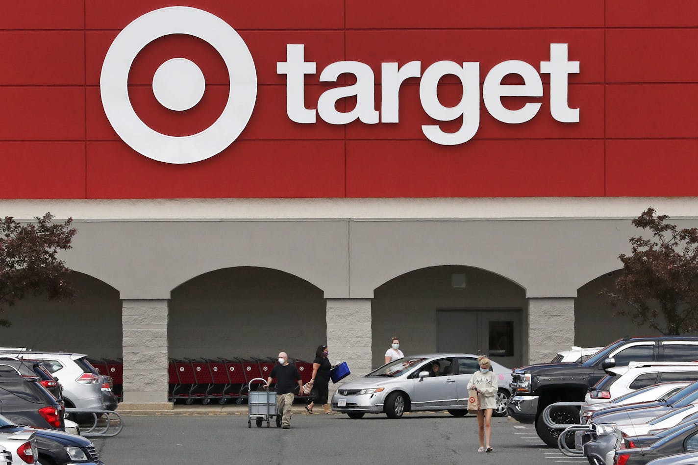 Target is extending a $2-an-hour pay bump and other benefits for store and distribution center workers. Shown is a store in Danvers, Mass. (AP Photo/Charles Krupa)