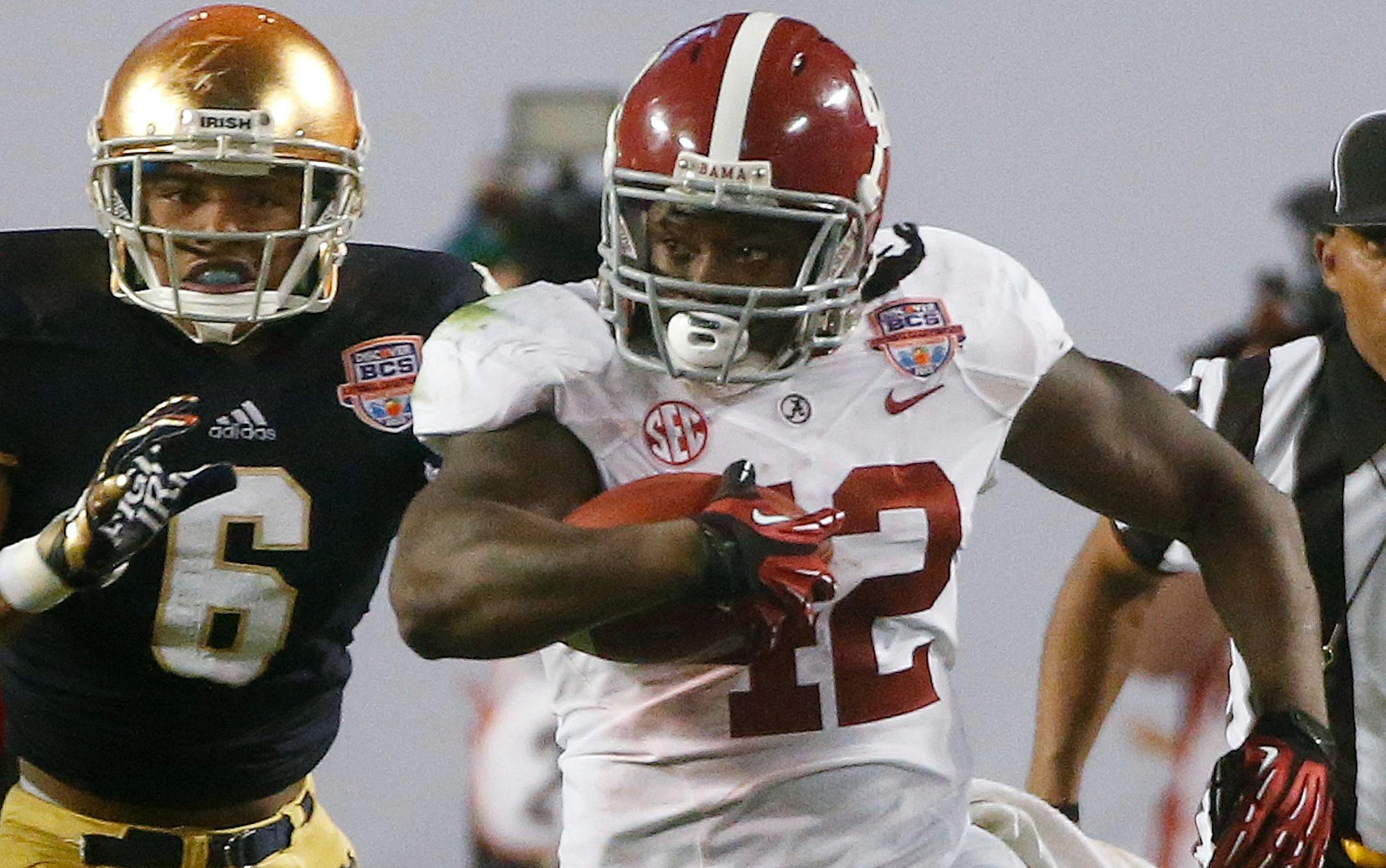 Alabama's Eddie Lacy (42) runs past Notre Dame cornerback KeiVarae Russell during the second half of the BCS National Championship game. Lacy signed an NFL contract with Green Bay.