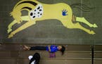 During a girls volleyball game, a girl and her friend relax in the bleachers in the gymnasium Tuesday, Sept. 16, 2014, at Little Wound k-12 school on 