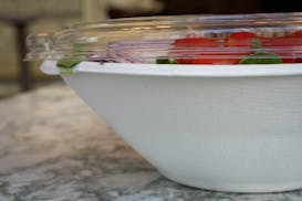 A to-go salad sits in a compostable bowl with a recyclable lid at Mother Dough in Capella Tower in Minneapolis. The restaurant recently started phasin