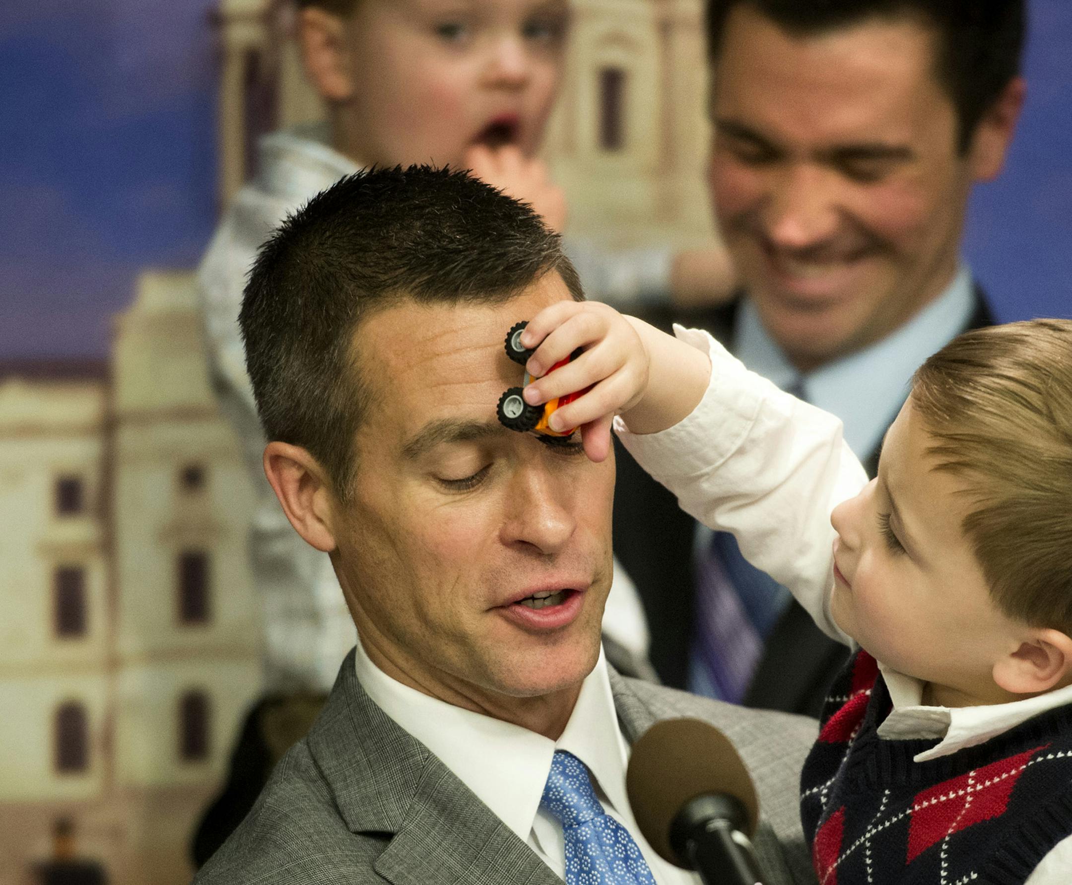 Dr. Paul Melchert got an unexpected car across the face from son Emmett while he spoke at the news conference. Behind him is husband James Zimmerman with the couple's other son Gabriel. Surrounded by same-sex couples and their children, Senator Scott Dibble and Rep. Karen Clark introduced their bill to legalize same-sex marriages in Minnesota. Wednesday, February 27, 2013. ] GLEN STUBBE * gstubbe@startribune.com