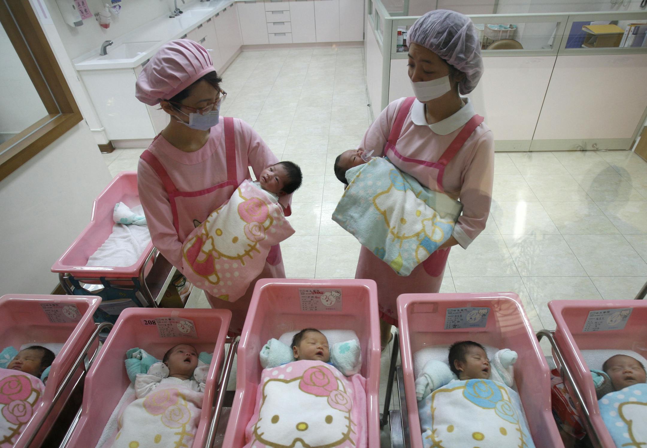 FILE - In this Jan. 20, 2009 file photo, nurses check on newborns, at the Hello Kitty-designed maternity ward, at the Hau Sheng hospital in the southern Taiwan city of Chunghua. Five years after the deepest global recession since the 1930s sent birth rates plunging around the world, many couples are still not having children. That’s good news if you’re worried about an overcrowded planet. But it’s bad for the economy. (AP Photo/Wally Santana, File)