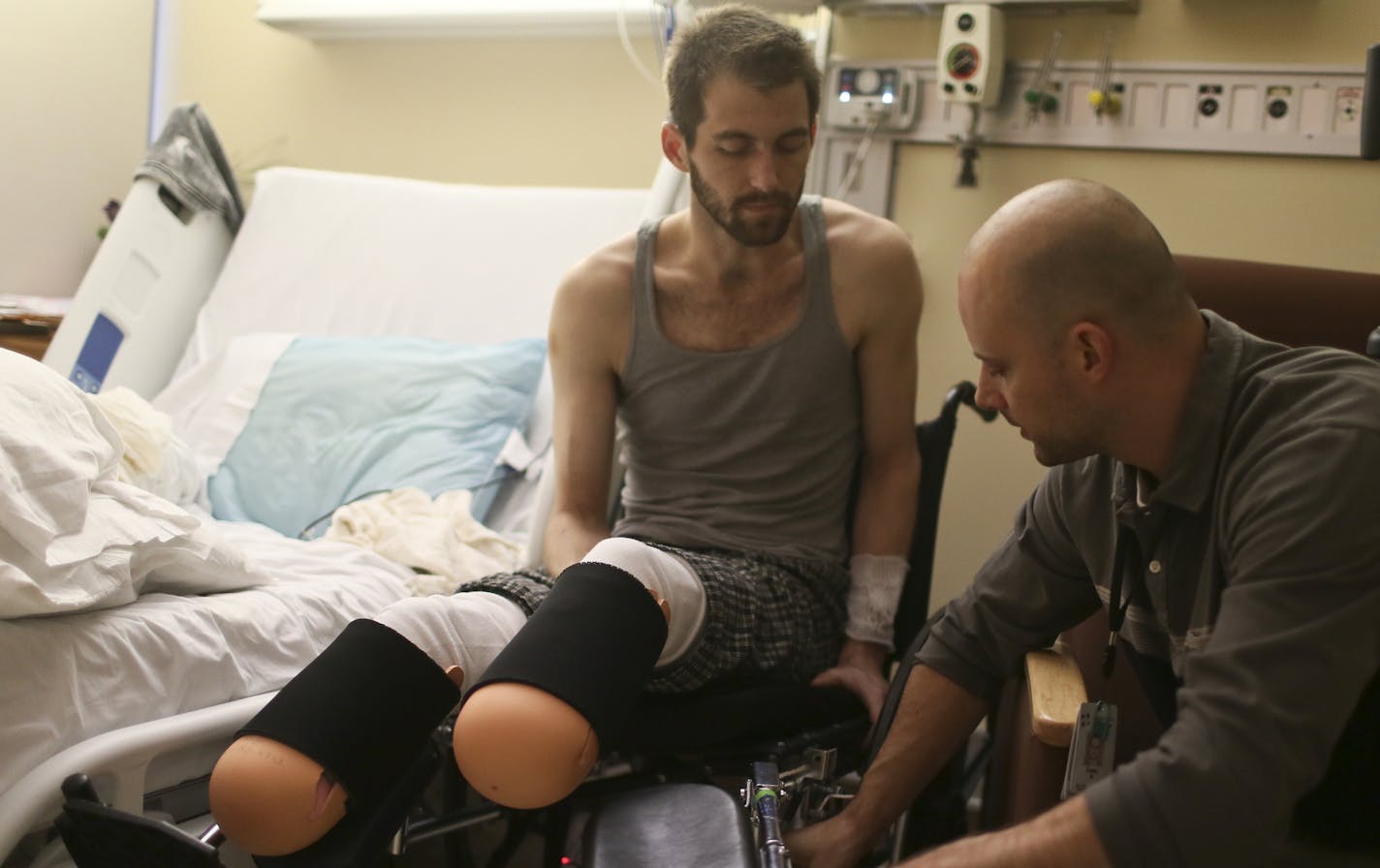 Daniel Edmonson talks to physical therapist Casey Byron who was showing him the features on his wheel chair from his hospital room at HCMC in Friday, Feb. 7, 2014, in Minneapolis, MN. Edmonson, who was hit by a train near Nicollet Island recently, lost the lower part of both legs.](DAVID JOLES/STARTRIBUNE) djoles@startribune.com Doctors were unable to save the legs of Daniel Edmonson, who was hit by a train near Nicollet Island recently.**Daniel Edmonson, Casey Byron, cq