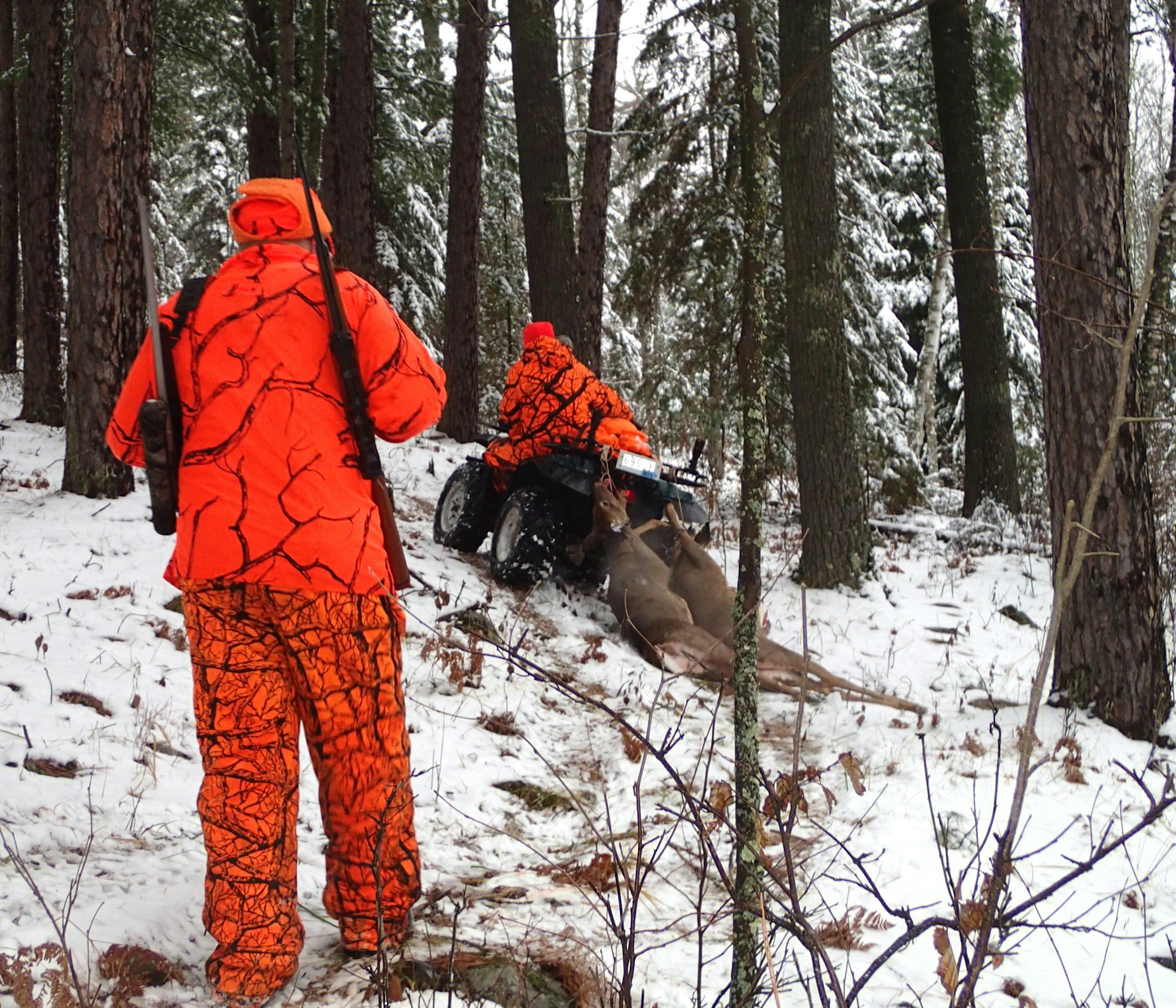 Hunting with Dennis Anderson on Saturday in northern Minnesota were, left, his brother Dick, his nephew Brian, on four-wheeler, and his son, Cole. Wet snow fell early in the morning.
