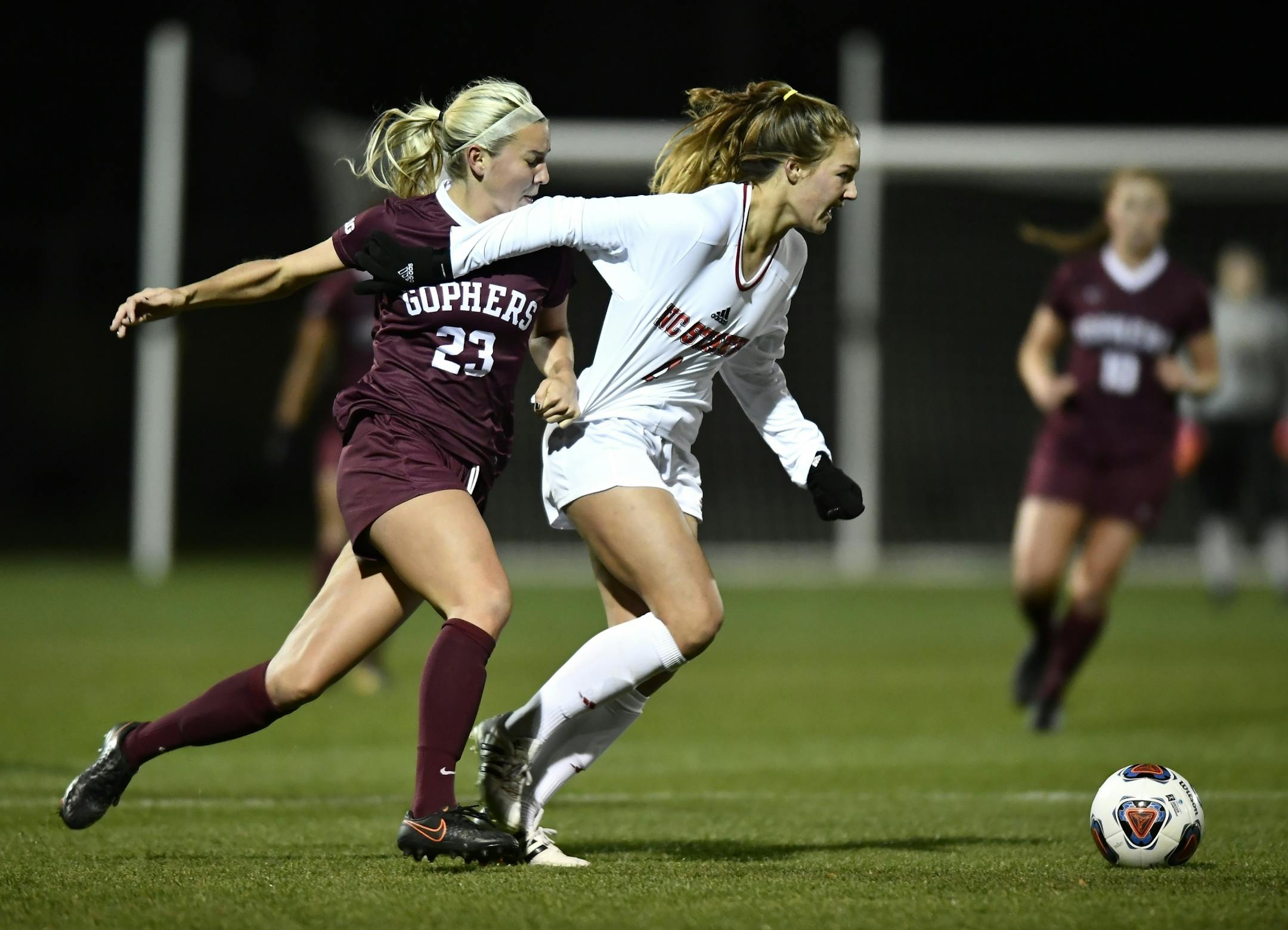 Minnesota forward Julianna Gernes (23) grabbed the jersey of NC State midefielder Hannah Keogh (4) in the first half Saturday.