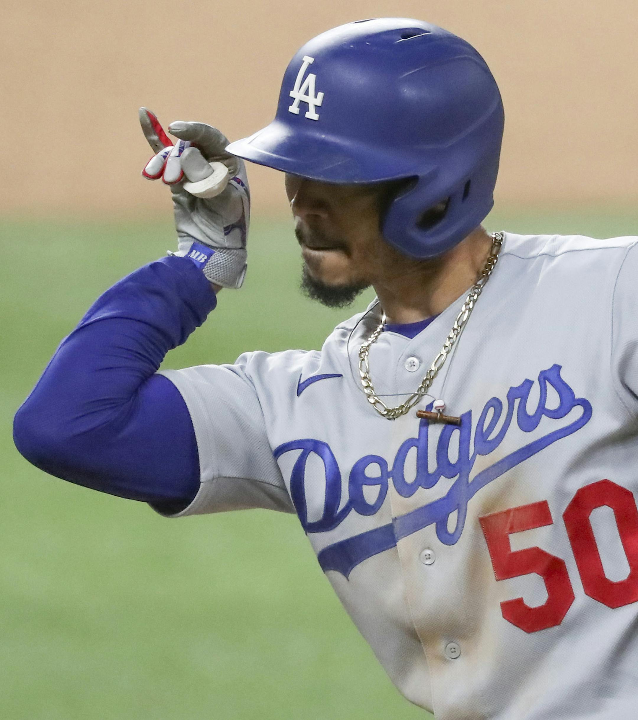 The Los Angeles Dodgers' Mookie Betts celebrates his RBI single in the seventh inning against the Atlanta Braves in Game 5 of the National League Championship Series on Friday, Oct. 16, 2020, at Globe Life Field in Arlington, Texas. (Curtis Compton/Atlanta Journal-Constitution/TNS)