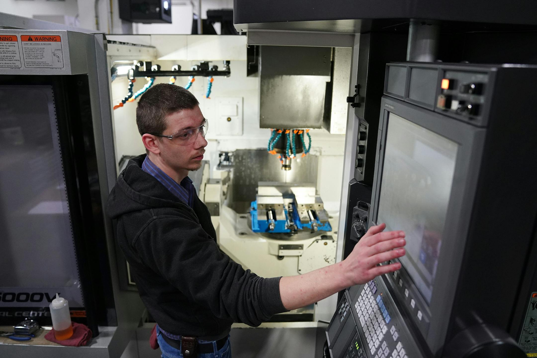 Machinist Derrik Richardson worked with a 5-axis computer numerical controlled milling machine to fabricate various parts for the aerospace industry. ] ANTHONY SOUFFLE • anthony.souffle@startribune.com Interview and tour with MRG Tool and Die president Rod Gramse of his facilities to discuss manufacturing on the job training Wednesday, Jan. 23, 2020 in Faribault, Minn.