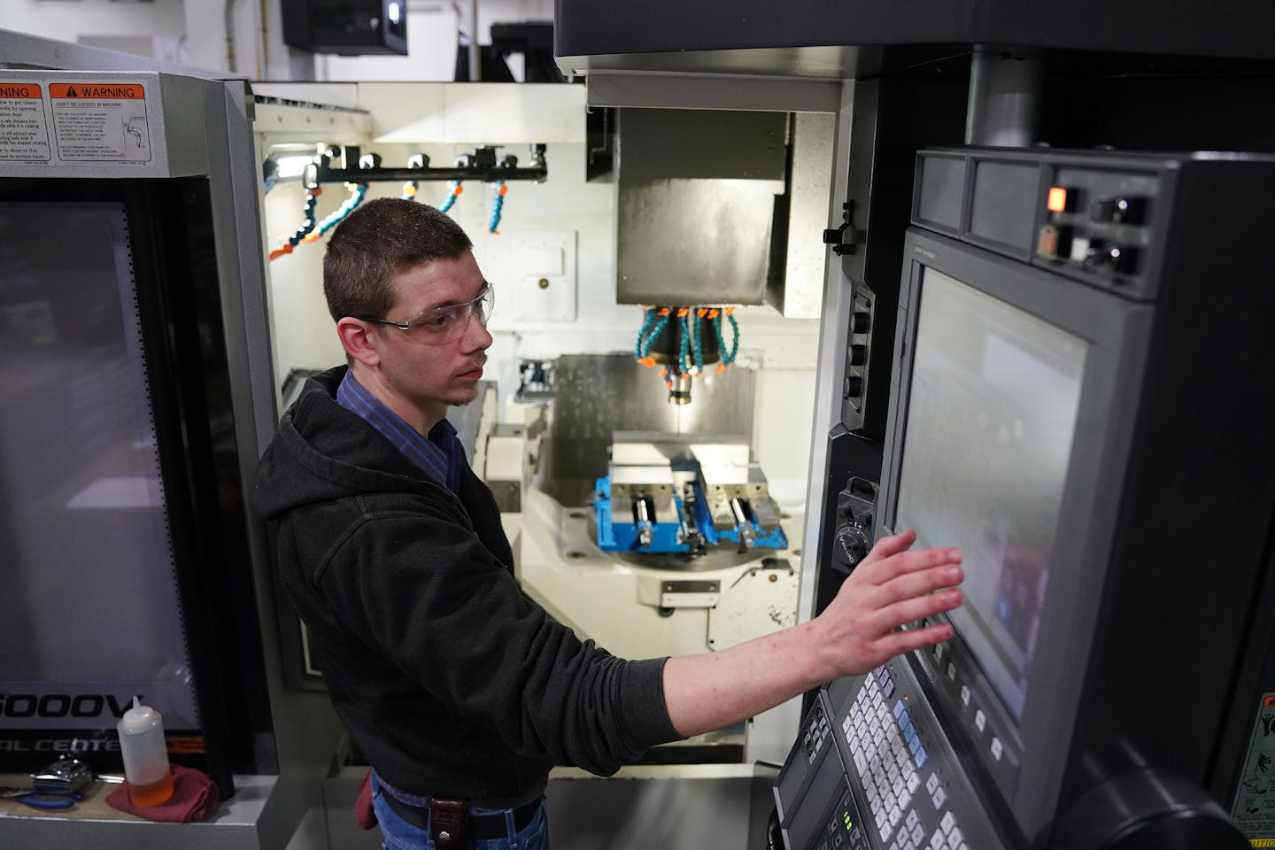 Machinist Derrik Richardson worked with a 5-axis computer numerical controlled milling machine to fabricate various parts for the aerospace industry. ] ANTHONY SOUFFLE &#x2022; anthony.souffle@startribune.com Interview and tour with MRG Tool and Die president Rod Gramse of his facilities to discuss manufacturing on the job training Wednesday, Jan. 23, 2020 in Faribault, Minn.