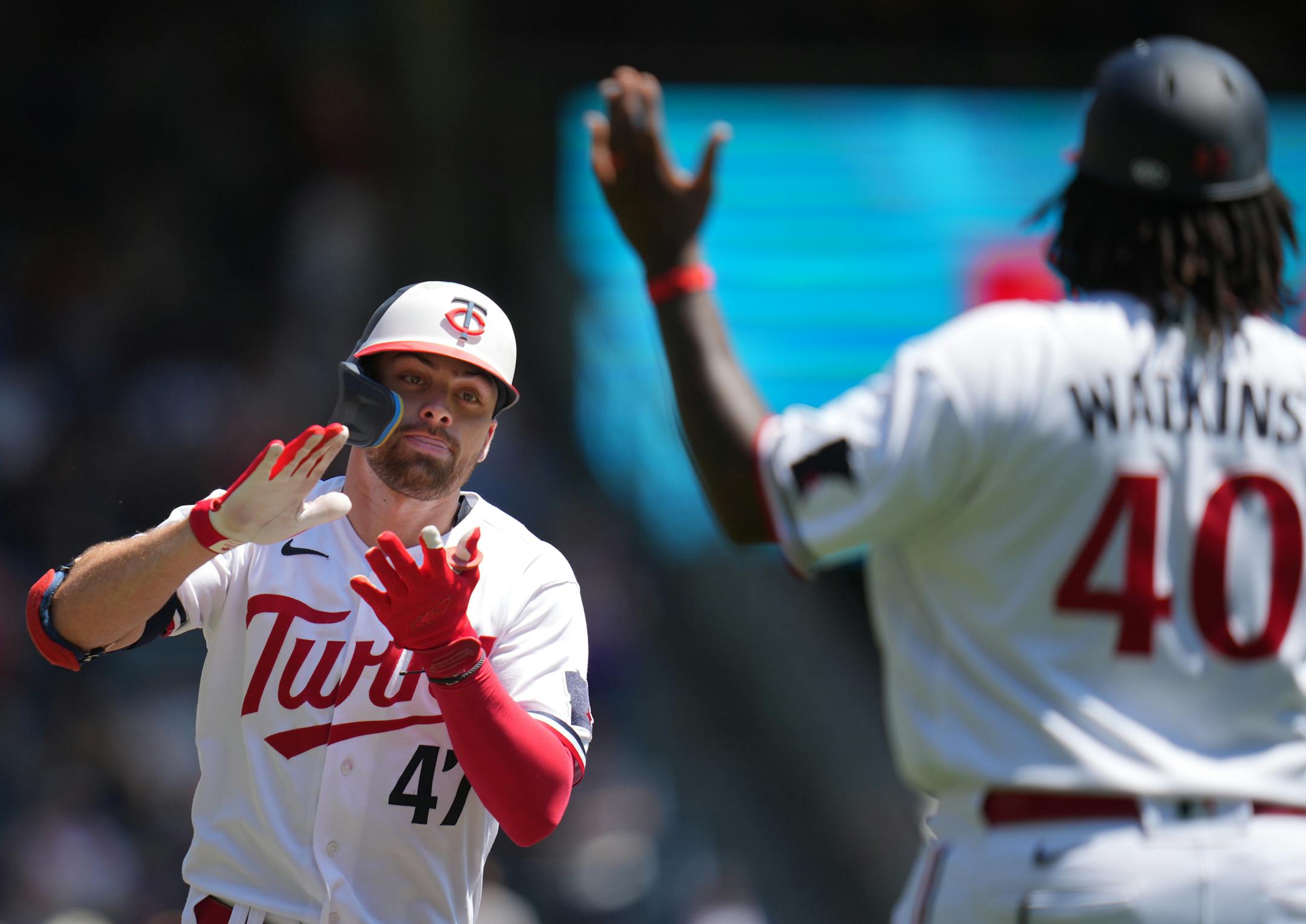 Minnesota Twins second baseman Edouard Julien (47) celebrates his home run in the third inning with Minnesota Twins third base coach/outfield coach Tommy Watkins (40).