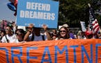 Protesters hold up signs during a rally supporting Deferred Action for Childhood Arrivals, or DACA, outside the White House on September 5, 2017. Thou