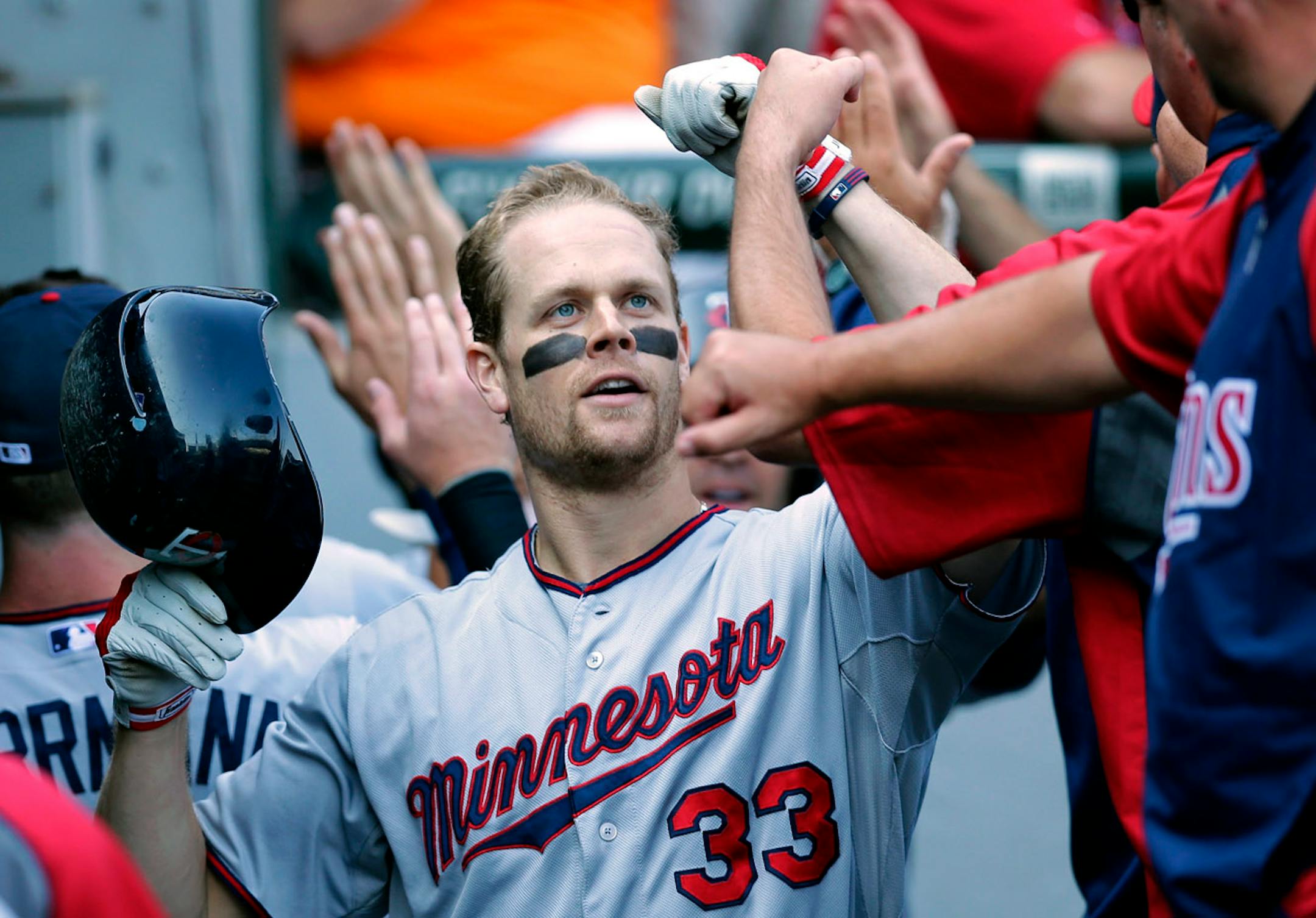 Minnesota Twins' Justin Morneau celebrates with teammates after hitting a three-run home run against the Chicago White Sox during the third inning of a baseball game in Chicago, Saturday, Aug. 10, 2013. (AP Photo/Nam Y. Huh)