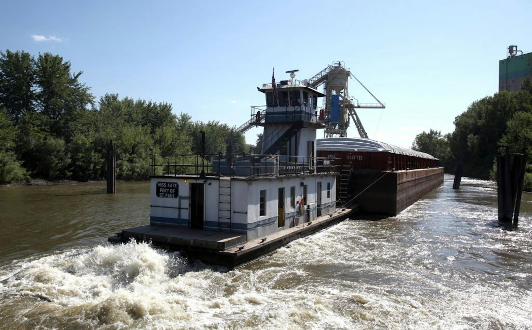 A tow boat moved a barge into place at Cenex Harvest States at their harbor in Savage n The Minnesota River.