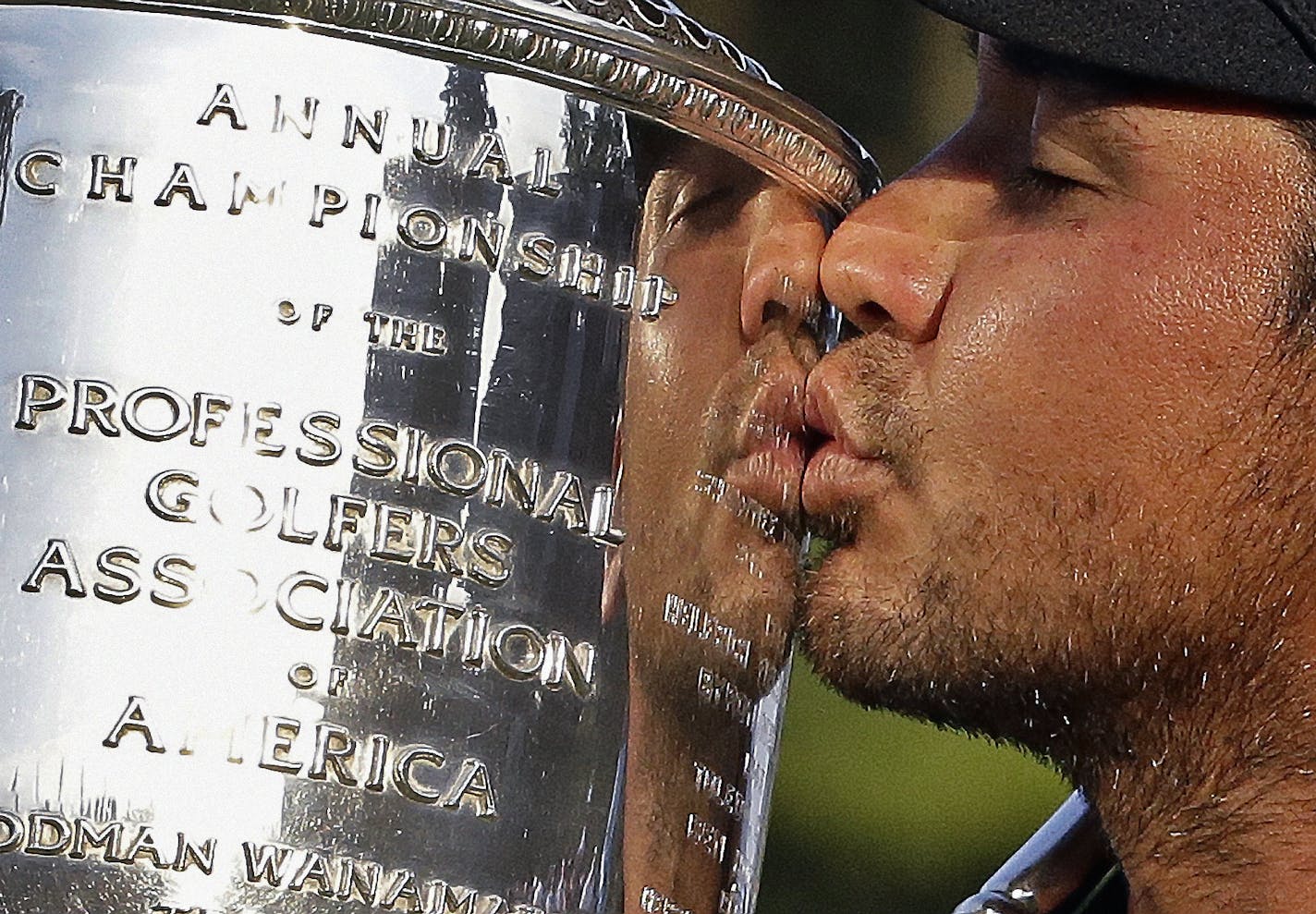 Jason Day, of Australia, kisses the Wanamaker Trophy after winning the PGA Championship golf tournament Sunday, Aug. 16, 2015, at Whistling Straits in Haven, Wis. (AP Photo/Brynn Anderson)