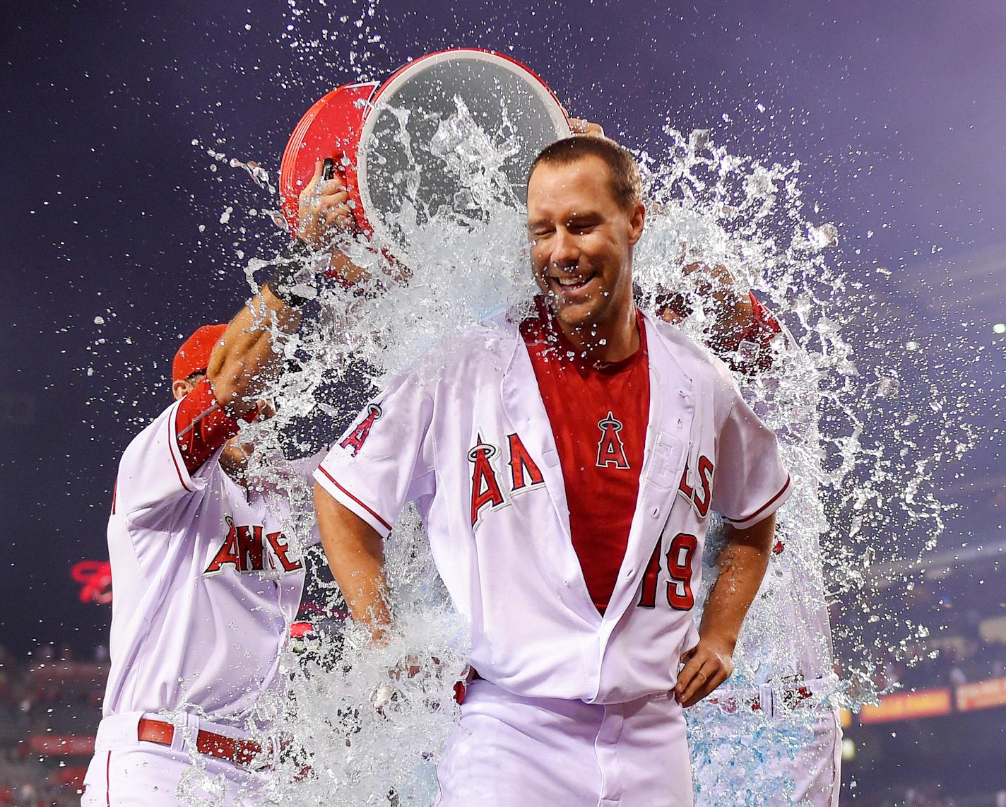 Los Angeles Angels' David Murphy, center, is doused with liquid by teammates Taylor Featherston, left, and Matt Joyce after Murphy hit a walk-off single to win in the ninth inning of a baseball game against the Oakland Athletics, Monday, Sept. 28, 2015, in Anaheim, Calif. The Angels won 5-4. (AP Photo/Mark J. Terrill)