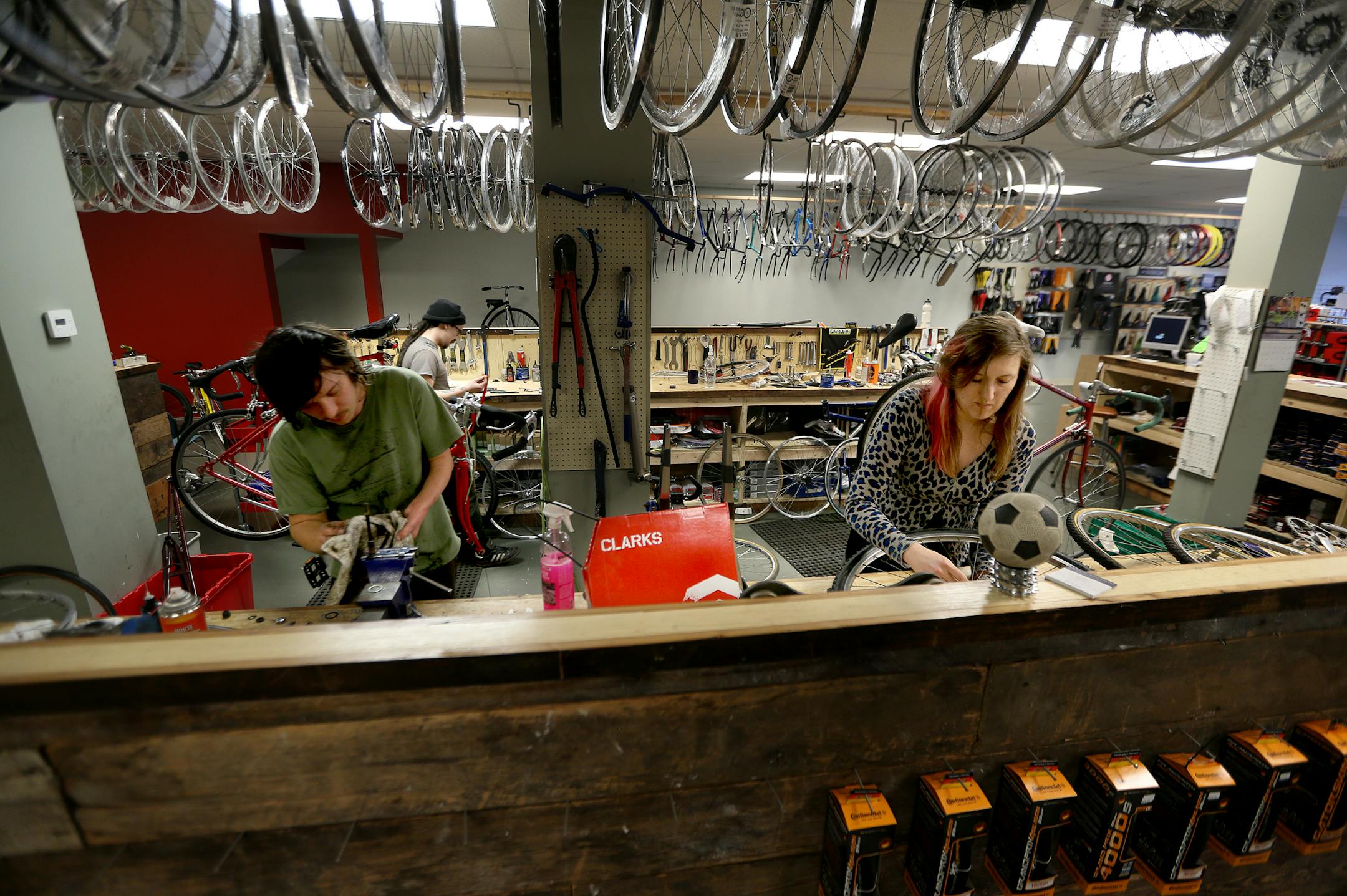 Caleb Belleveau, left, and Janneke Schaap of Recovery Bike Shop worked on bikes, Monday, December 2, 2013 in Minneapolis, MN. The shop is part of a new co-op development. (ELIZABETH FLORES/STAR TRIBUNE) ELIZABETH FLORES • eflores@startribune.com